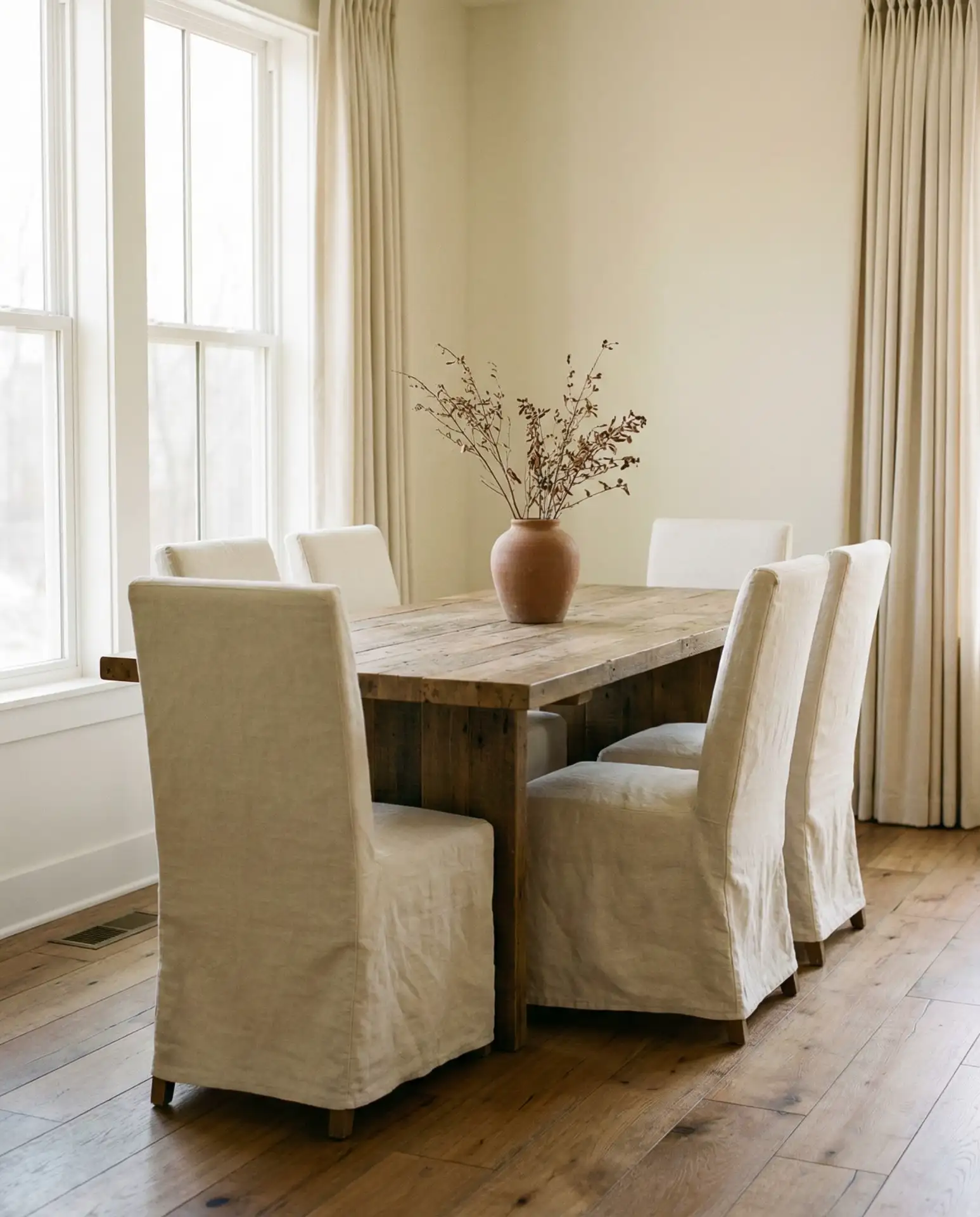 Linen-Draped Dining Chairs with Reclaimed-Wood Tables 2