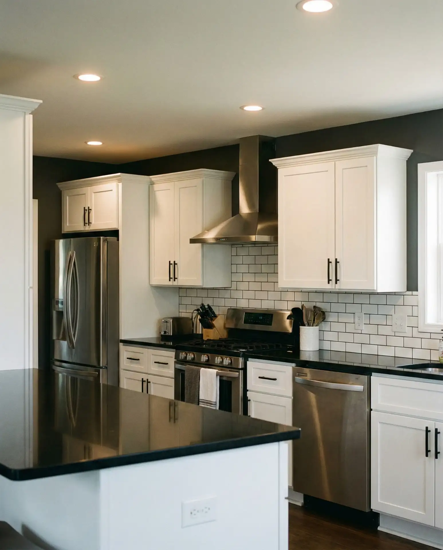 Charcoal Gray Walls with White Cabinets and Black Countertops 1