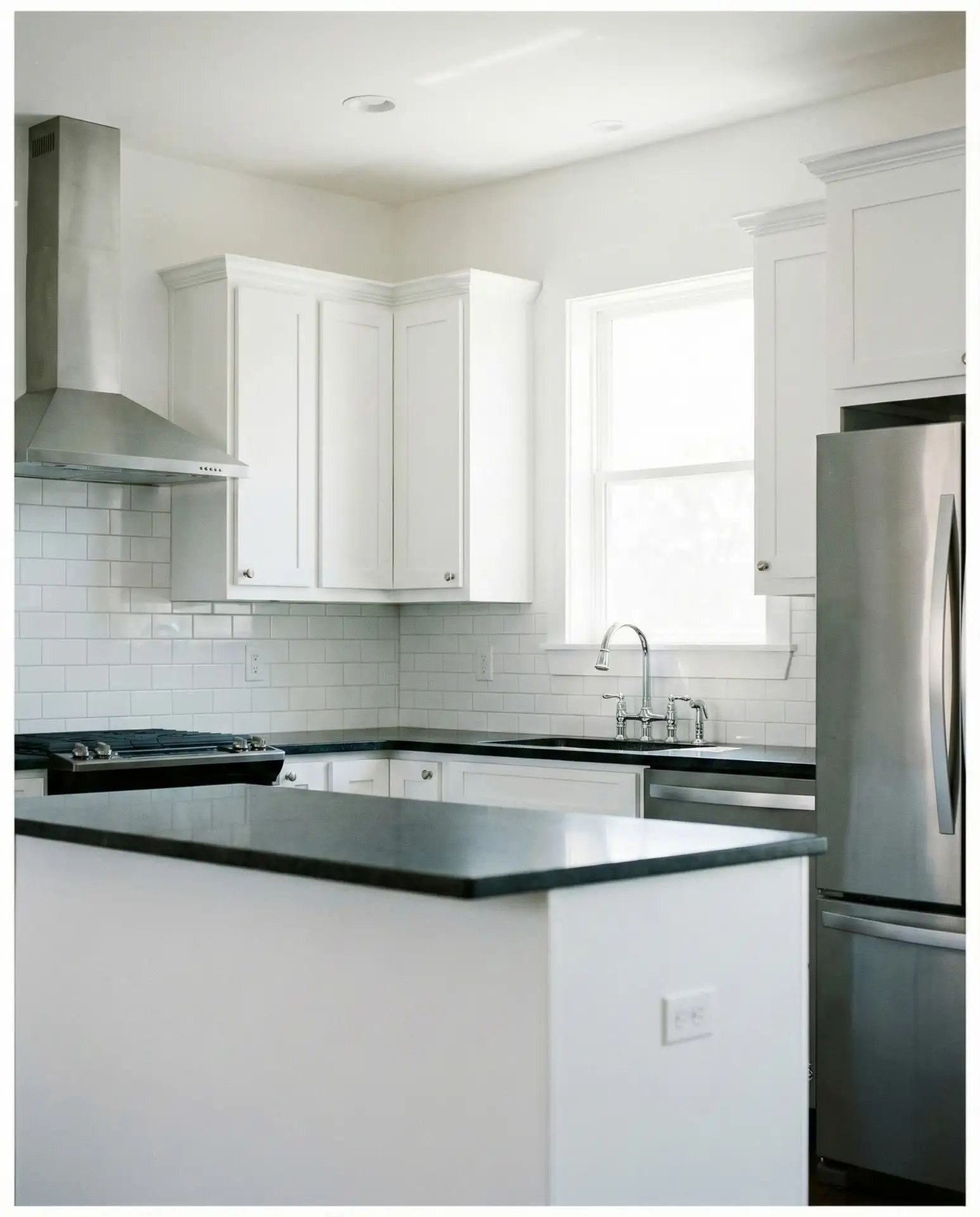 Crisp White Walls and White Cabinets with Black Countertops 1
