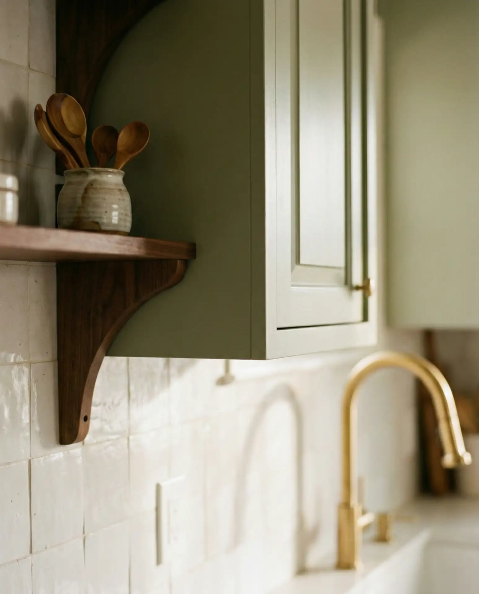 Sage Green Kitchen with White Tiles and Wood Accents 2