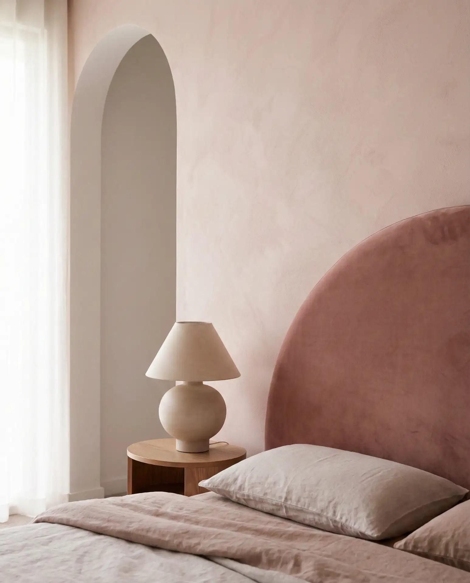 Soft Pink Bedroom with Curved Furniture and Arched Details 1