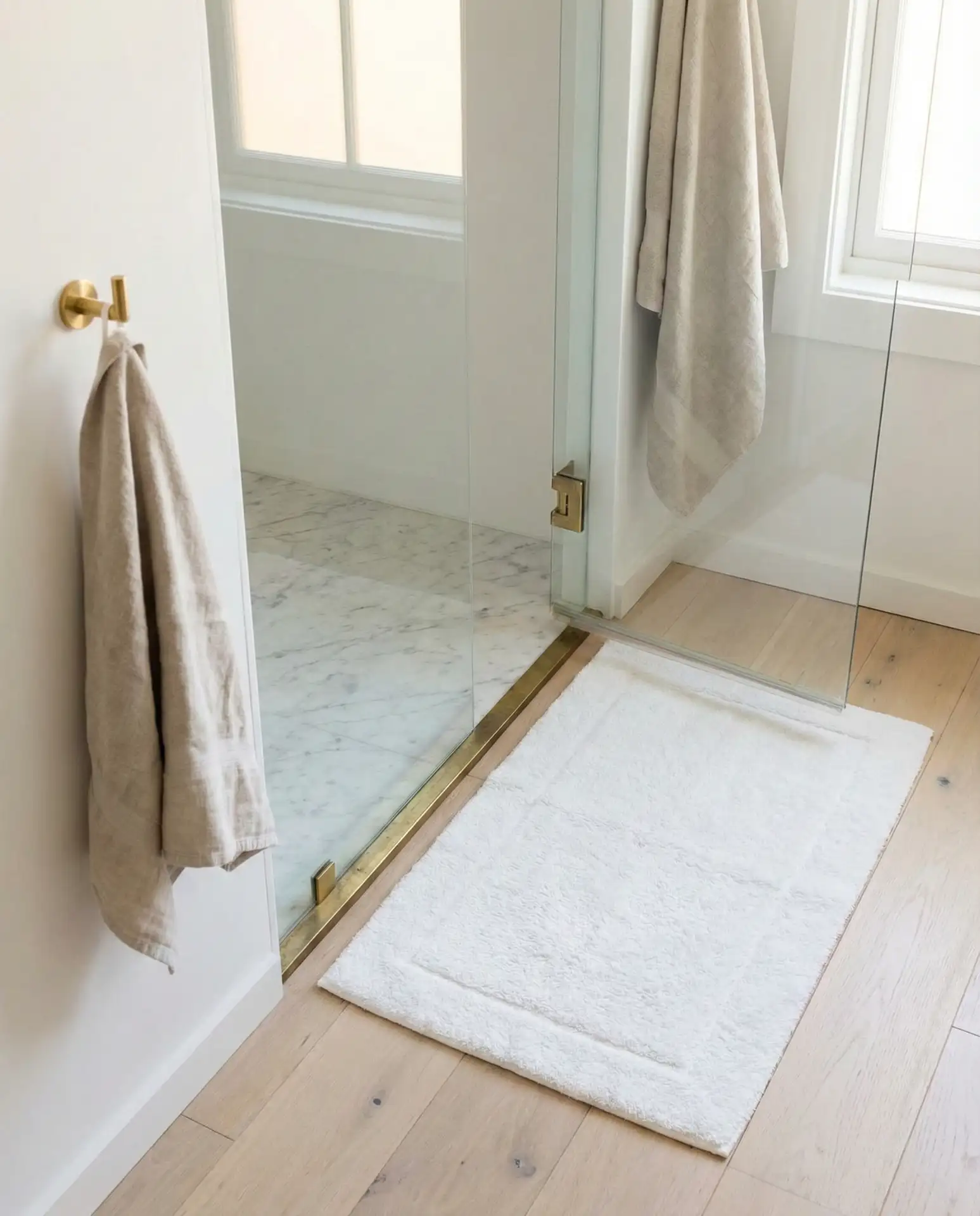 White Stone Corner Shower with Polished Details 1