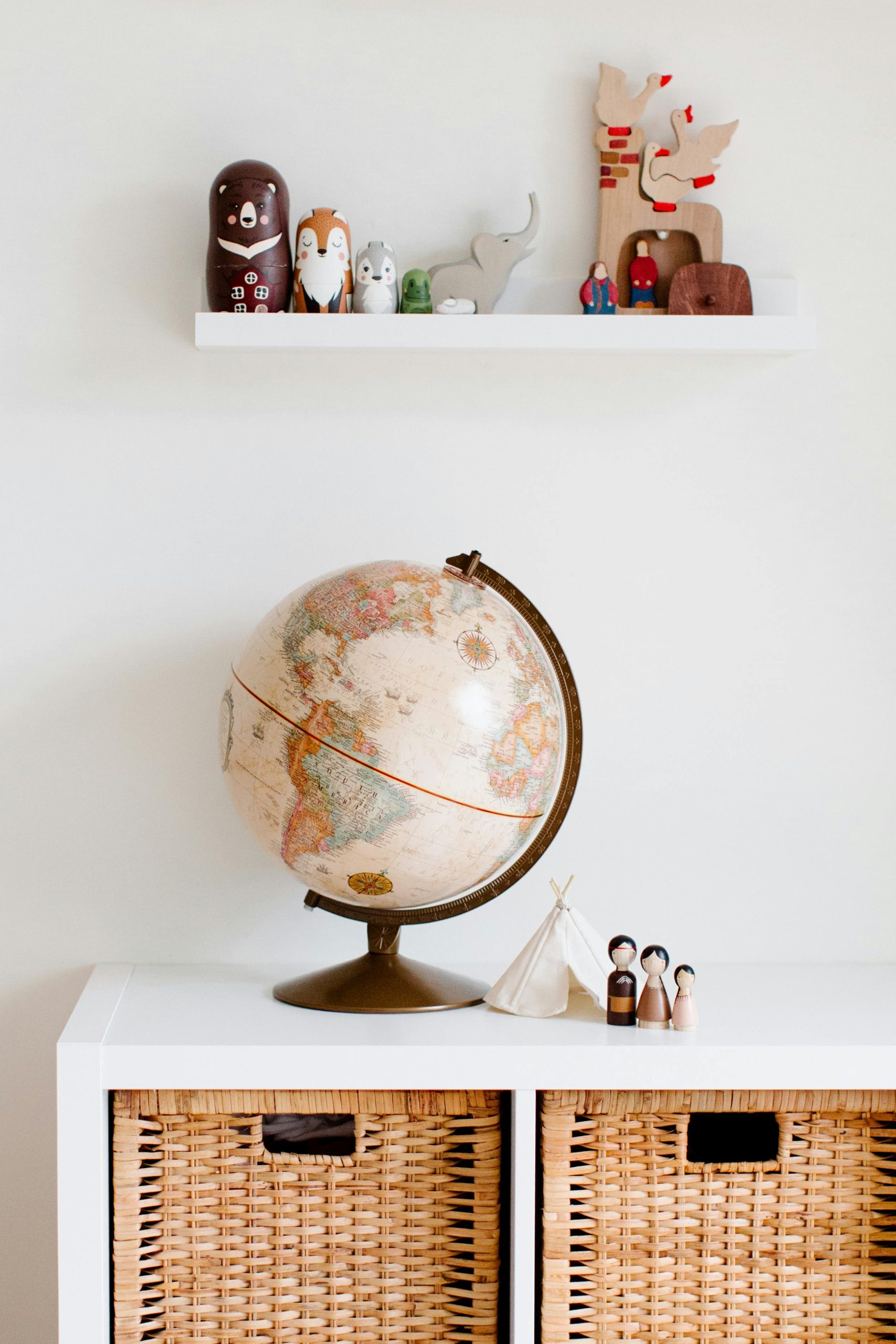 Cozy children's room with globe and toys, blending modern and vintage decor styles.