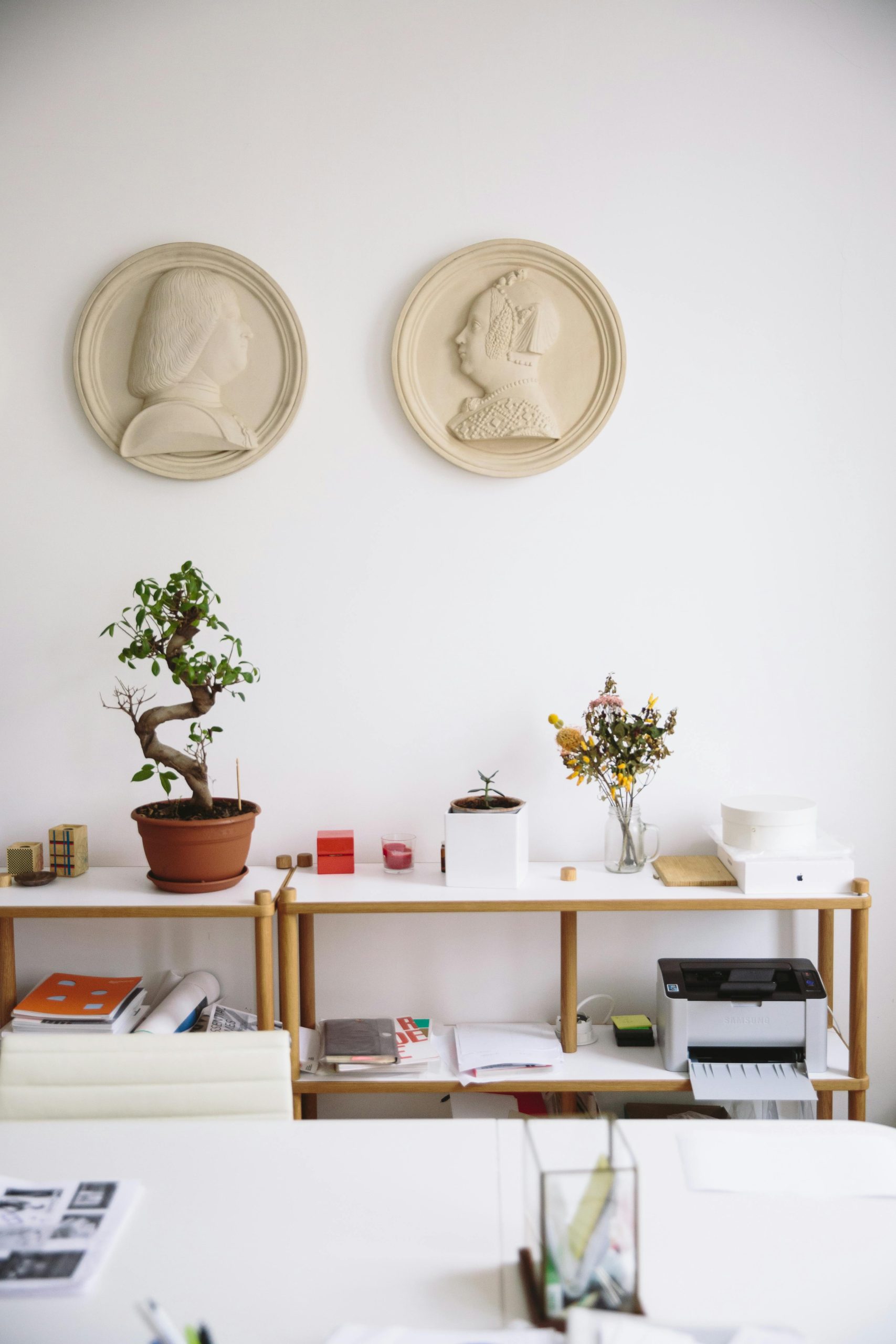 Stylish office featuring modern decor, art pieces, and functional furnishings.