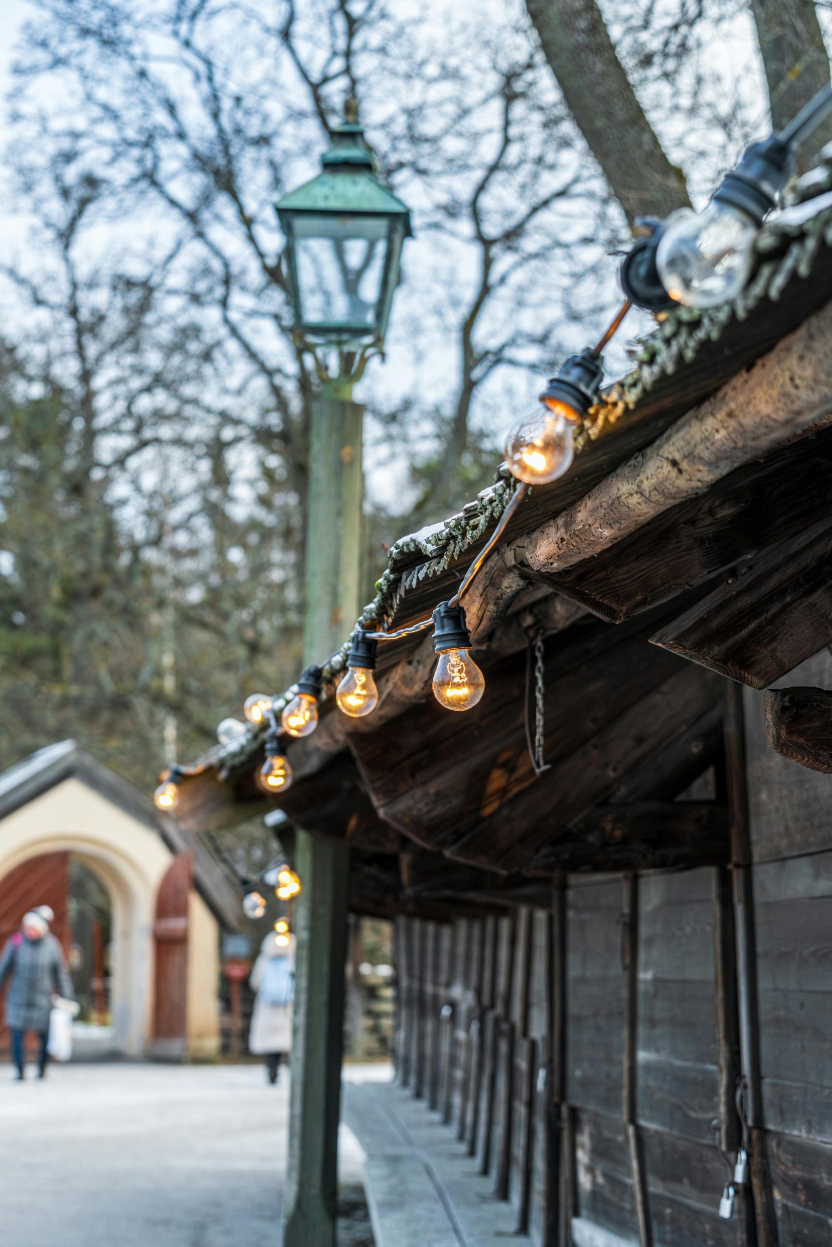 A cozy market stall decorated with string lights during winter in Stockholm, Sweden.