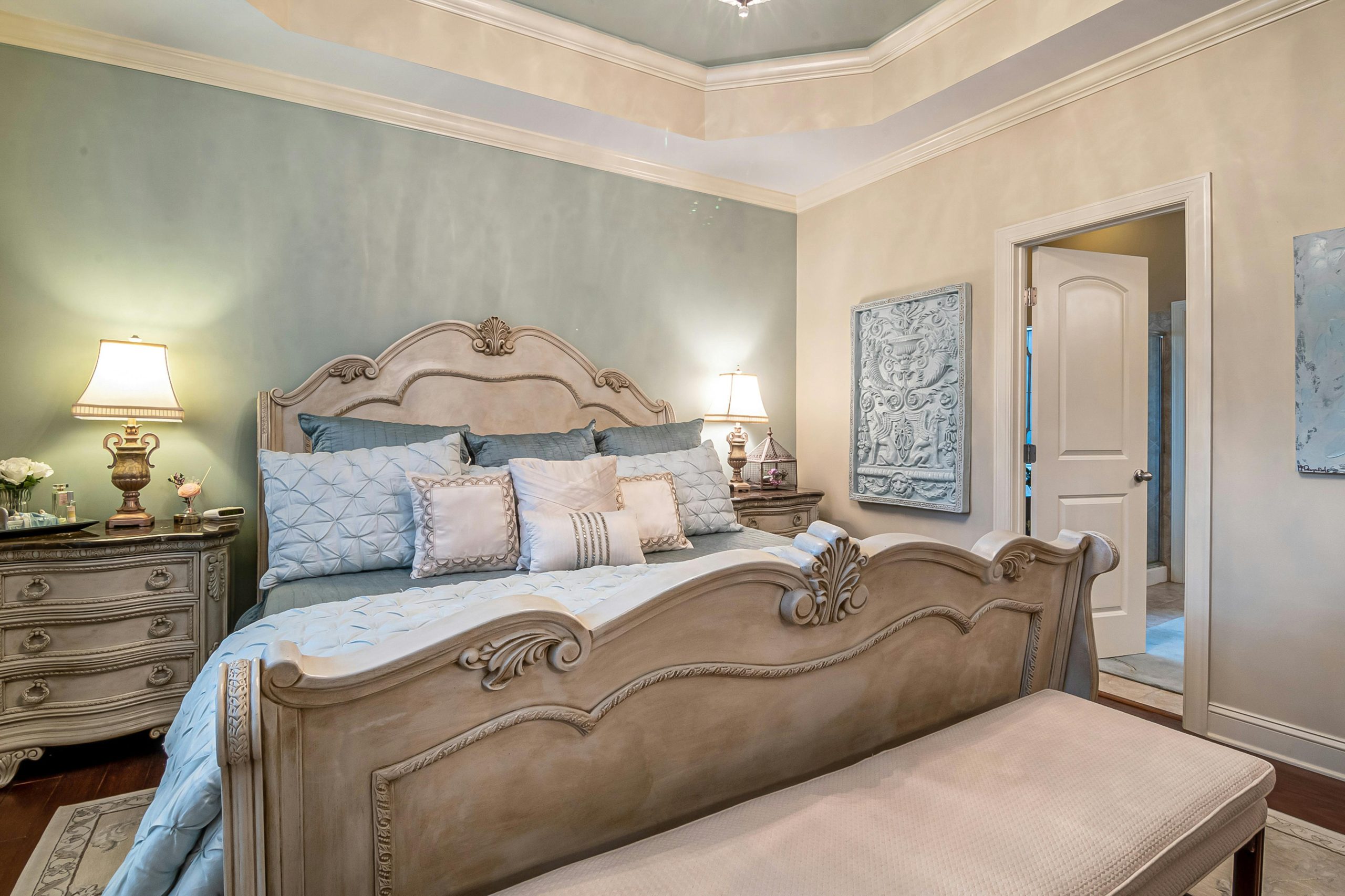 A lavishly decorated bedroom featuring classic furniture, soft lighting, and elegant decor.