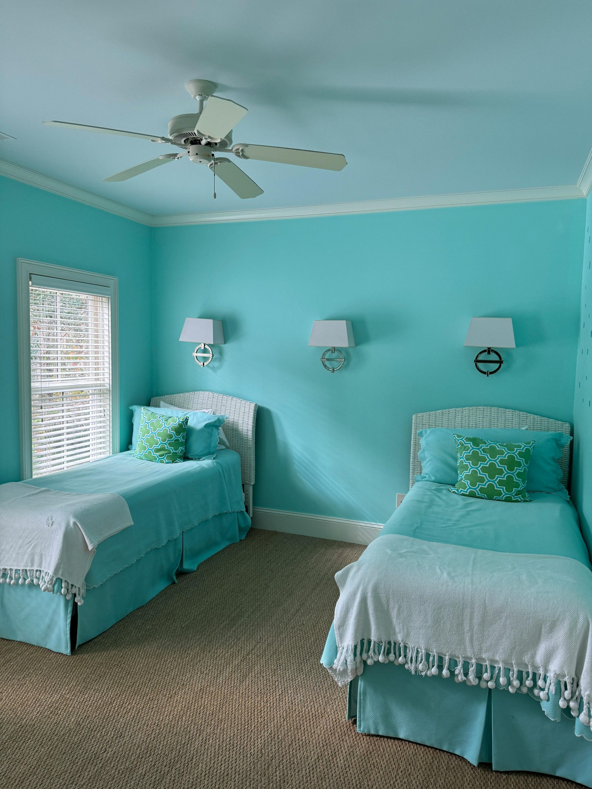 A serene aqua-themed bedroom with twin beds, perfect for a relaxing coastal vibe.