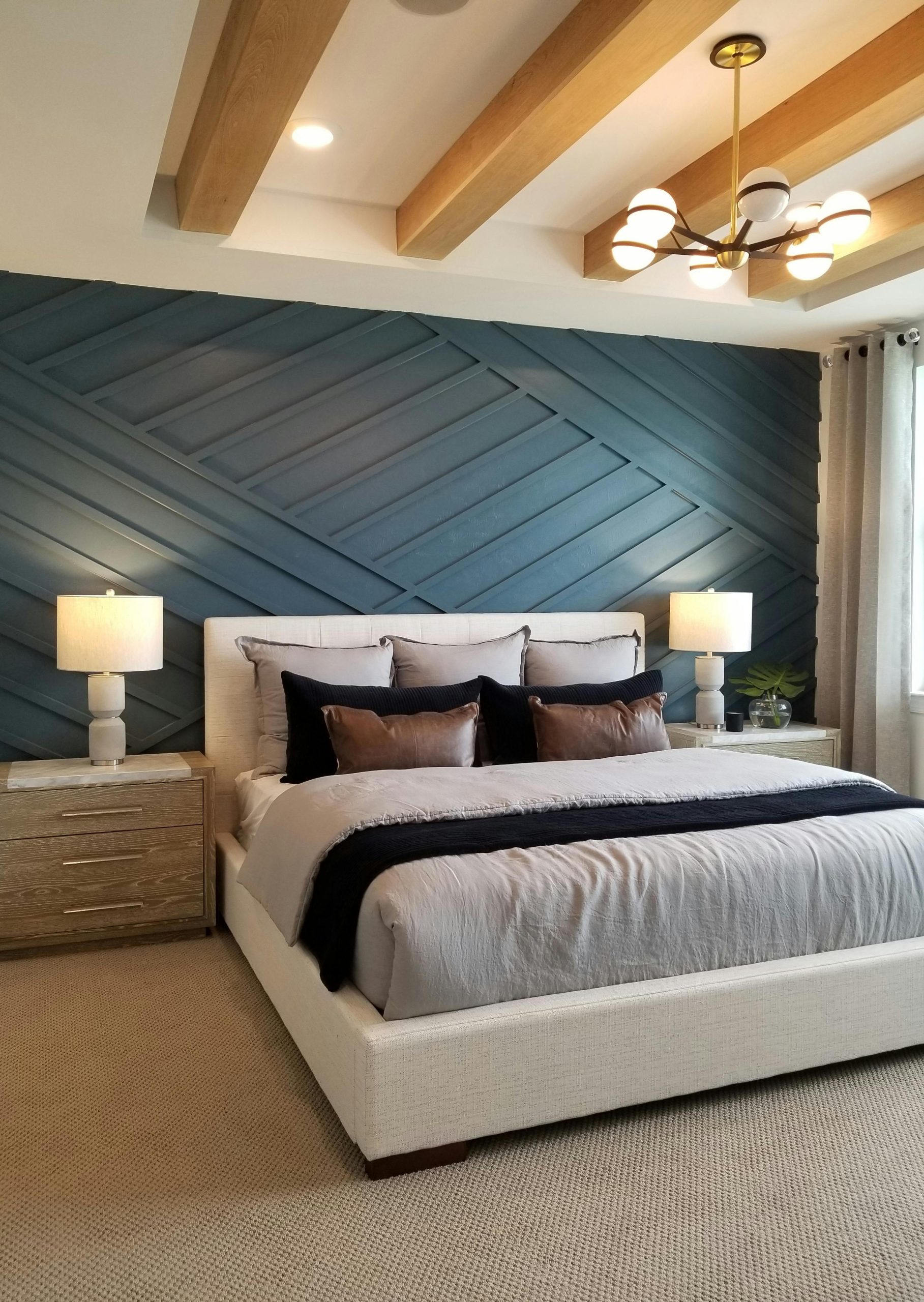 A stylish bedroom featuring a contemporary design with wood accents and soft lighting.
