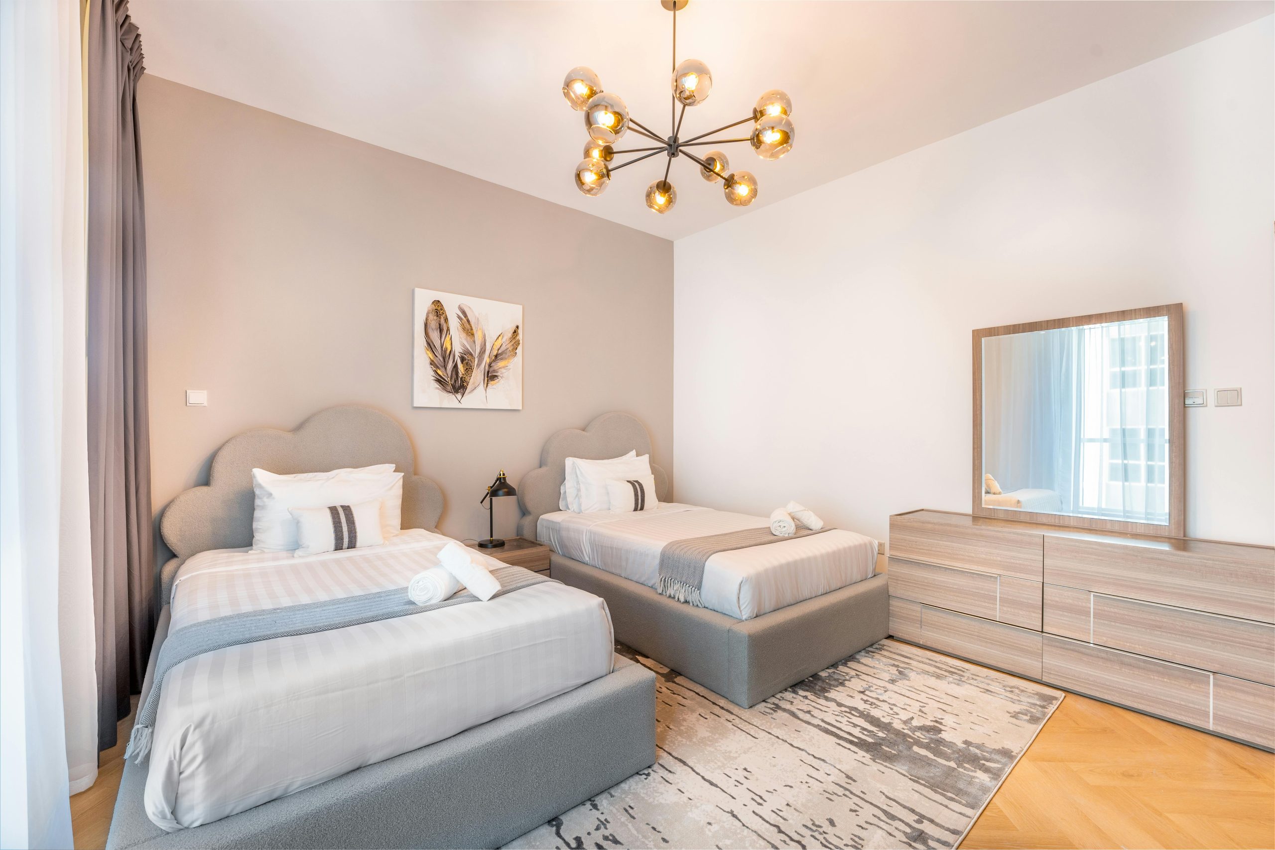 A stylish modern twin bedroom with elegant decor and warm lighting ambiance.