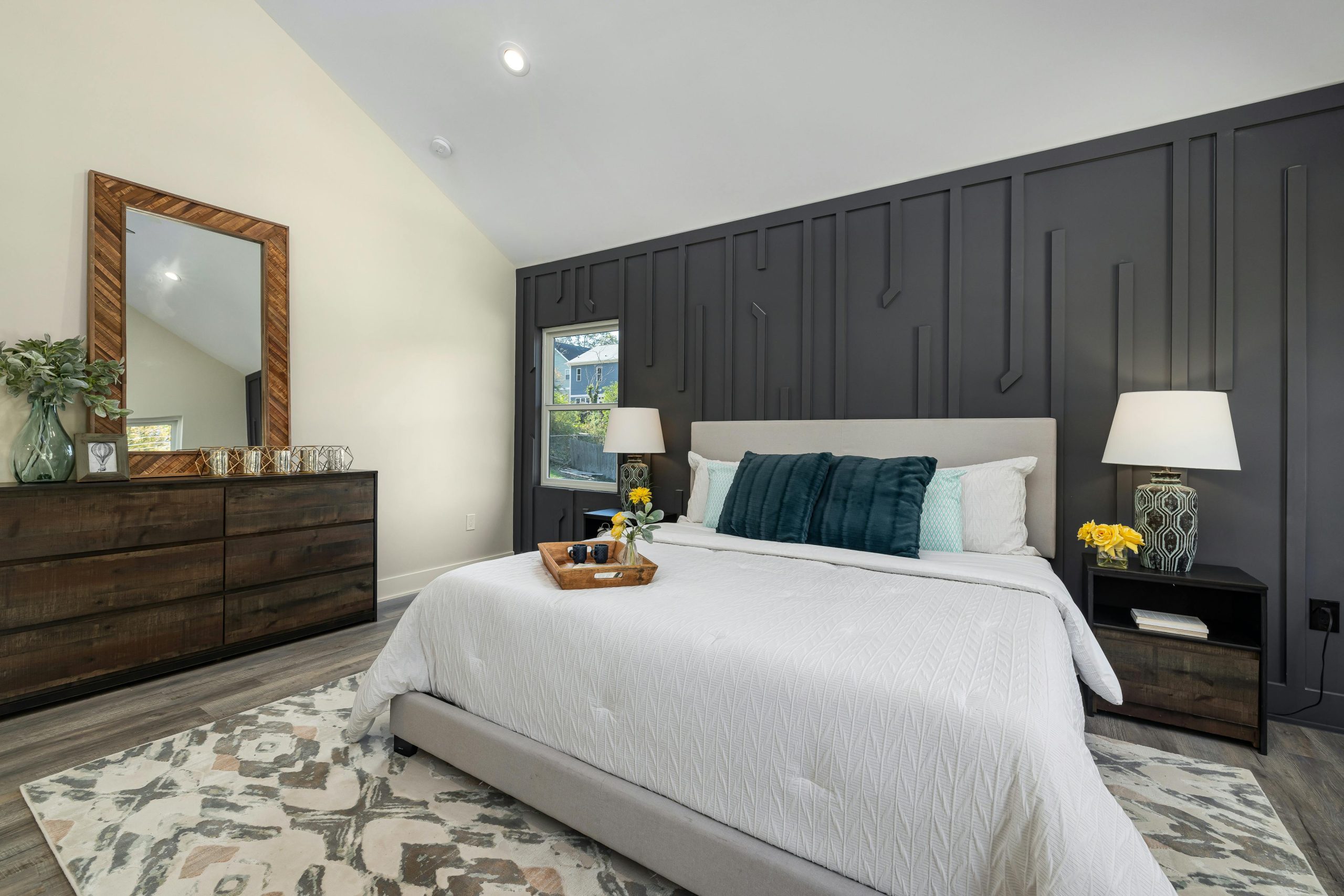 A tastefully decorated modern bedroom with stylish furniture and ambient lighting.