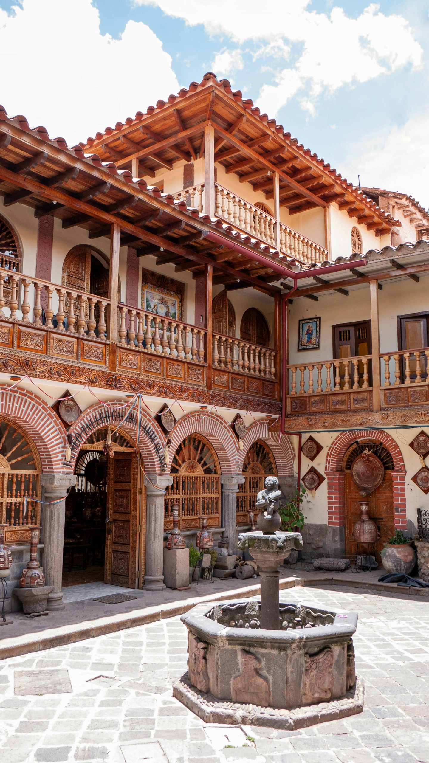 Beautiful colonial architecture in a Cusco courtyard featuring a central fountain.