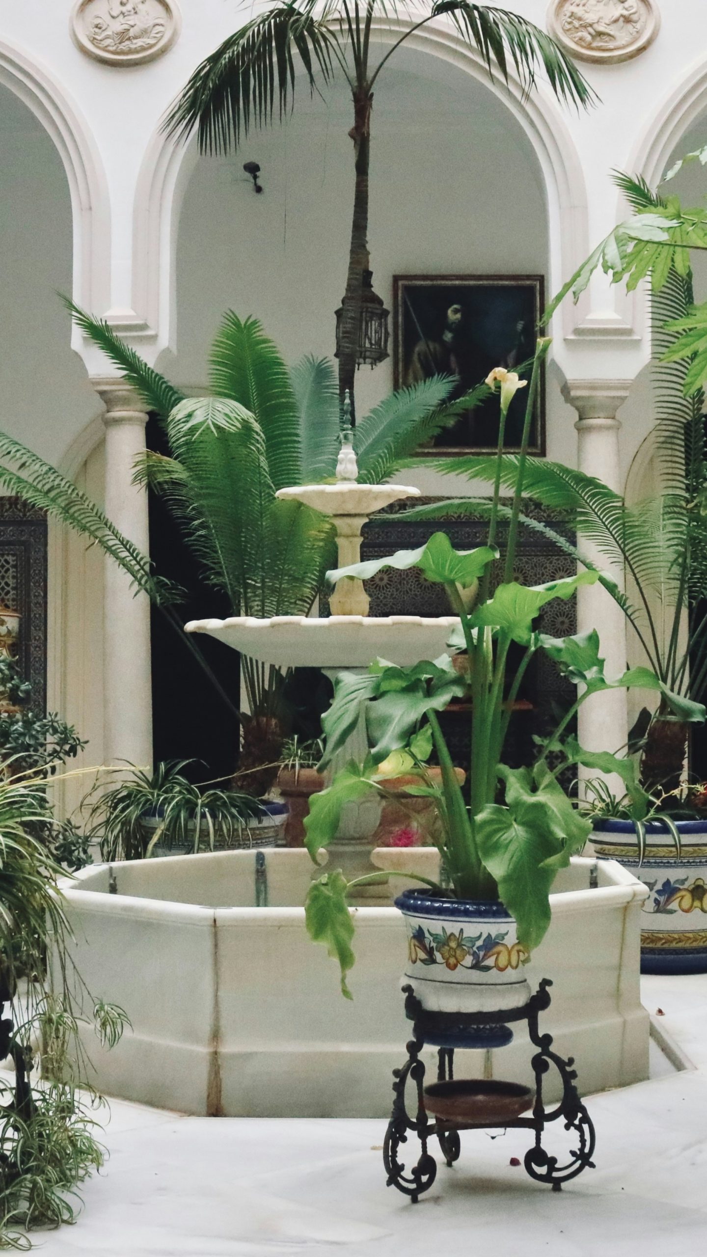 Courtyard with fountain and lush green plants