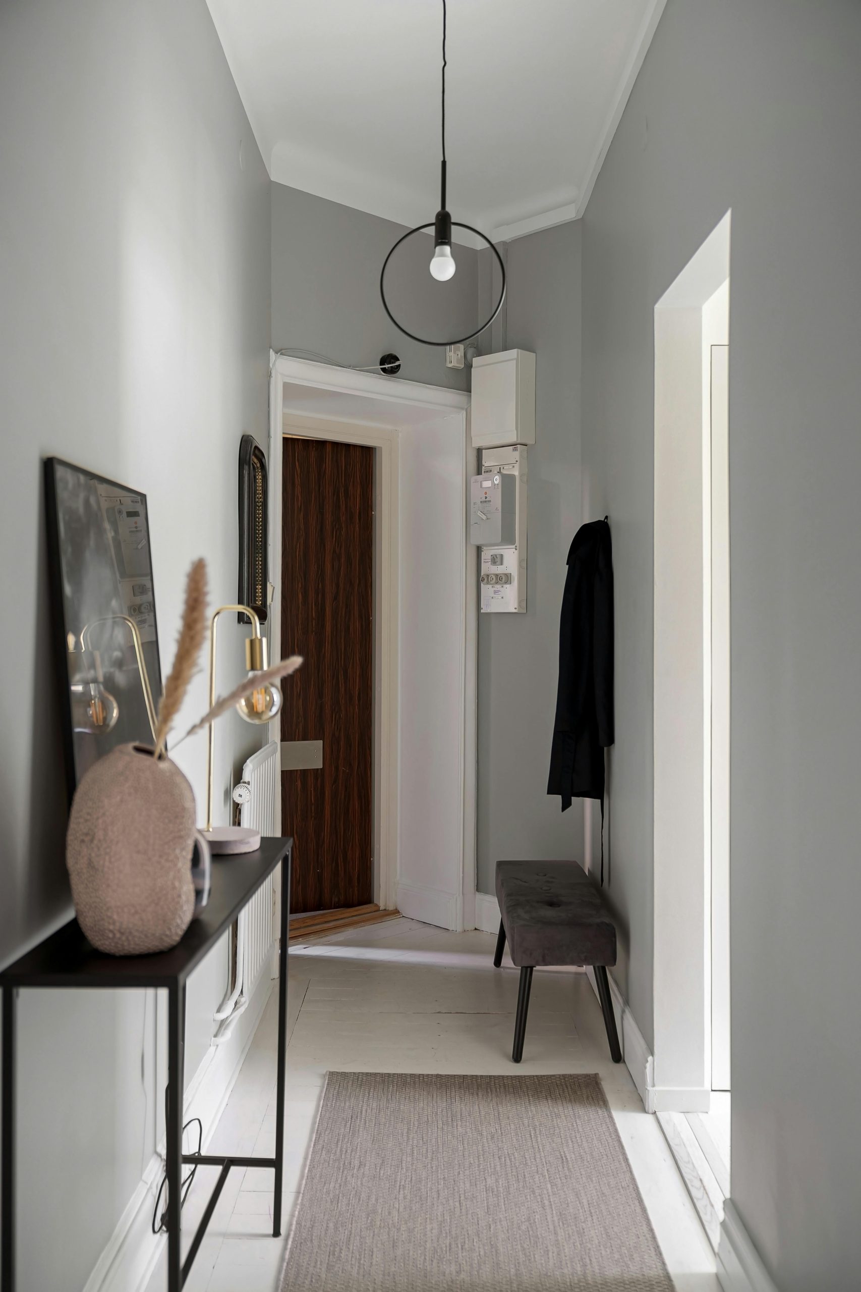 Elegant minimalist hallway with modern decor and natural lighting.