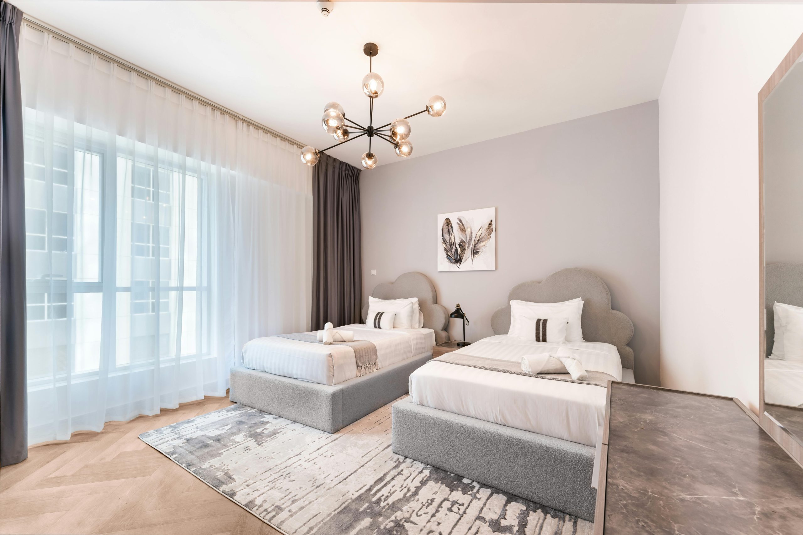 Elegant modern bedroom with twin beds and contemporary design elements.