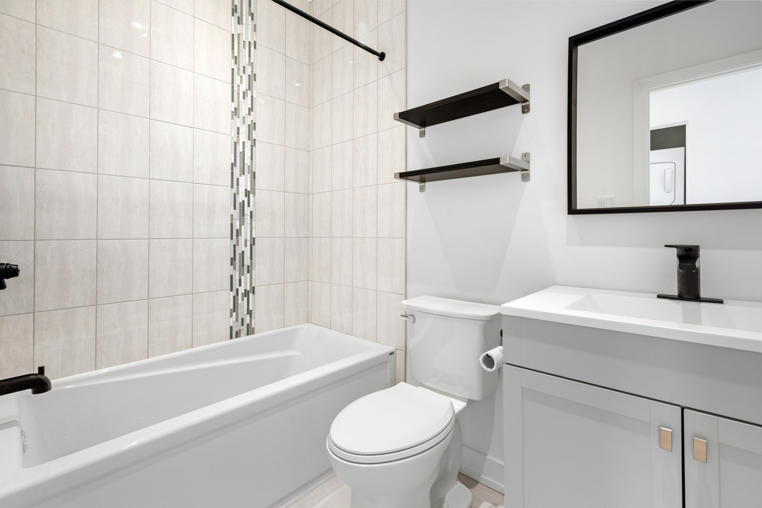 a bathroom with a tub toilet and sink