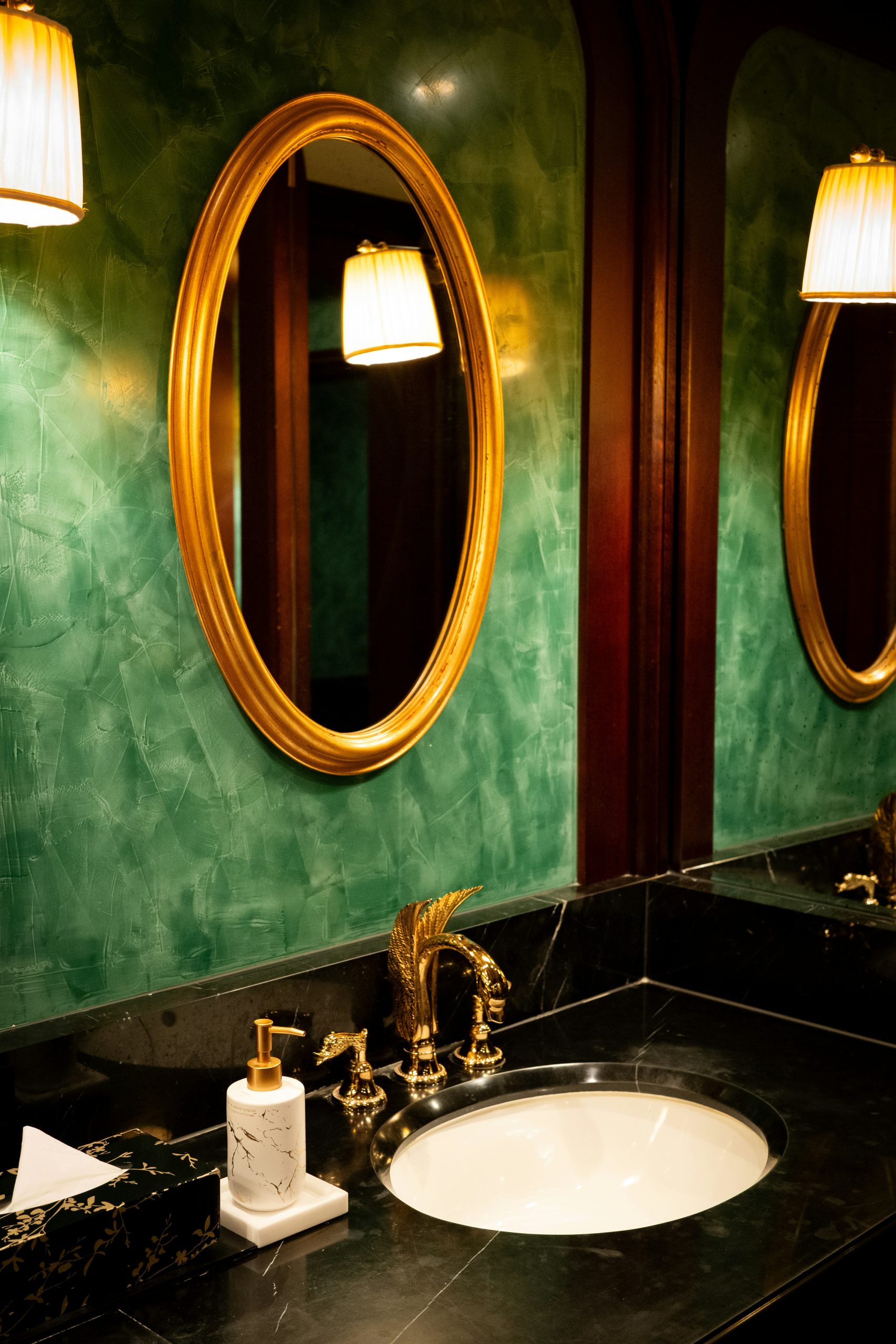 A bathroom with two sinks and two mirrors