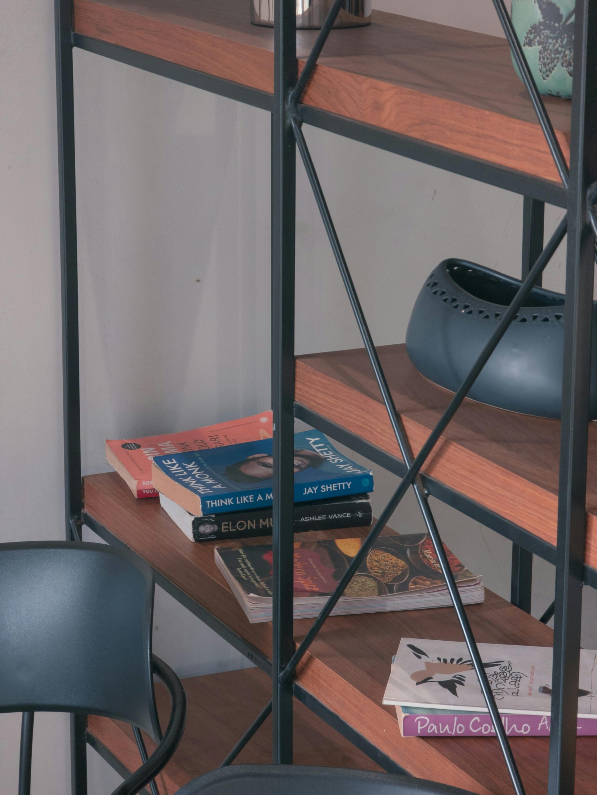 A stylish bookshelf with a mix of books and modern decor items, perfect for a contemporary interior.