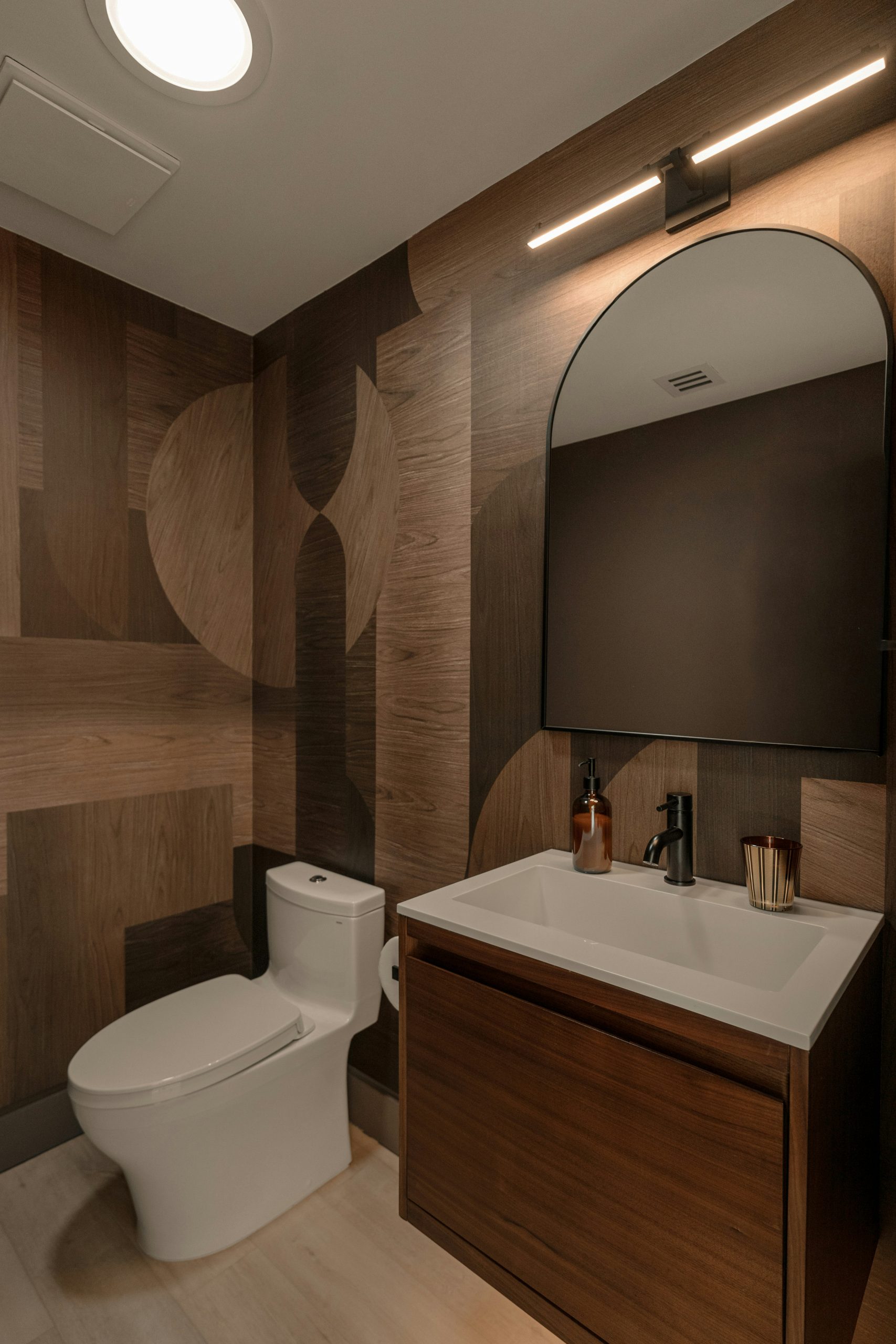 An elevated Palm Springs bathroom remodel blending natural stone, warm wood cabinetry, and spa-inspired lighting. Shot for an architectural designer to showcase luxury renovation details.