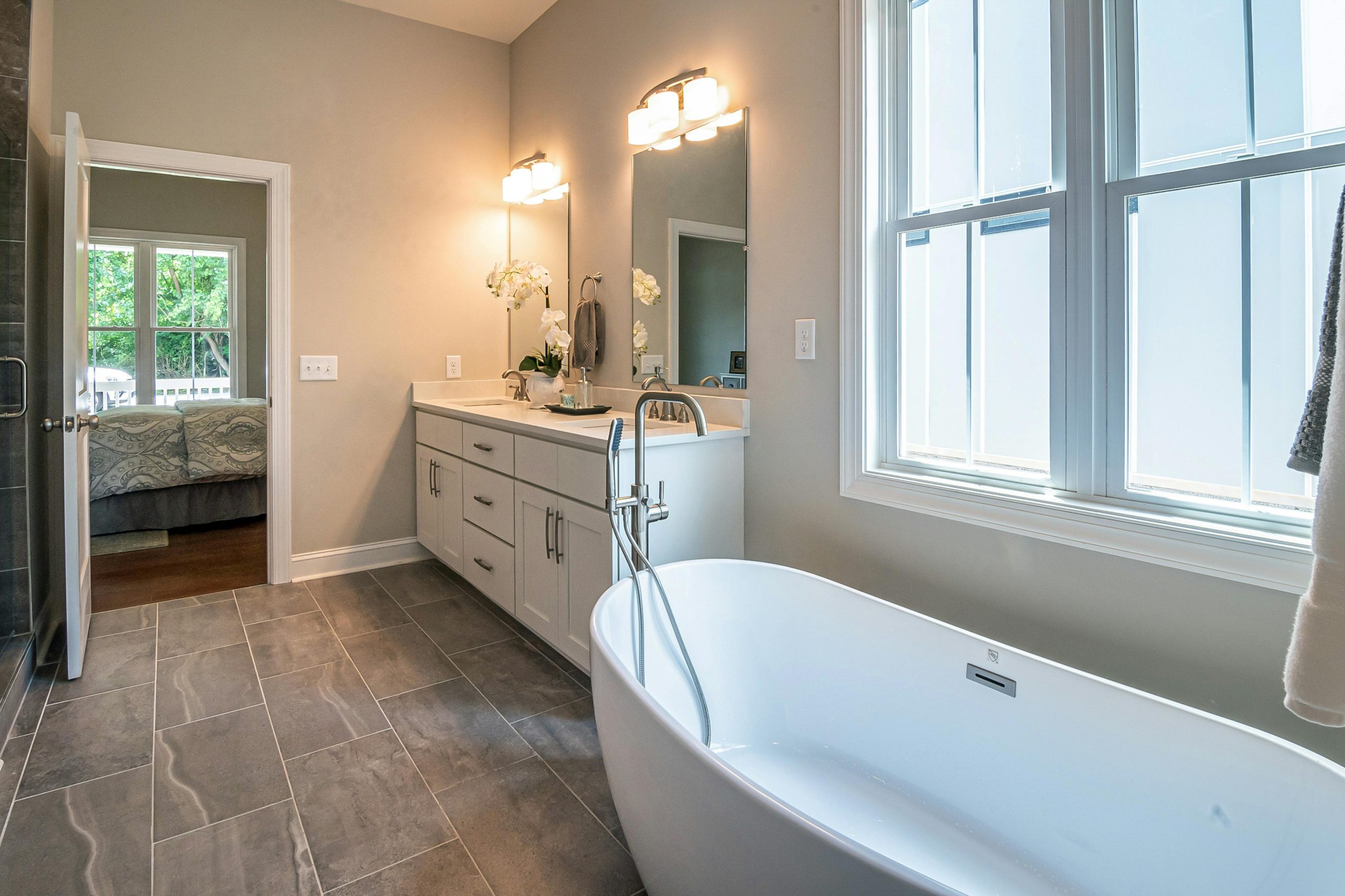 Bright and elegant bathroom with freestanding tub and modern design.