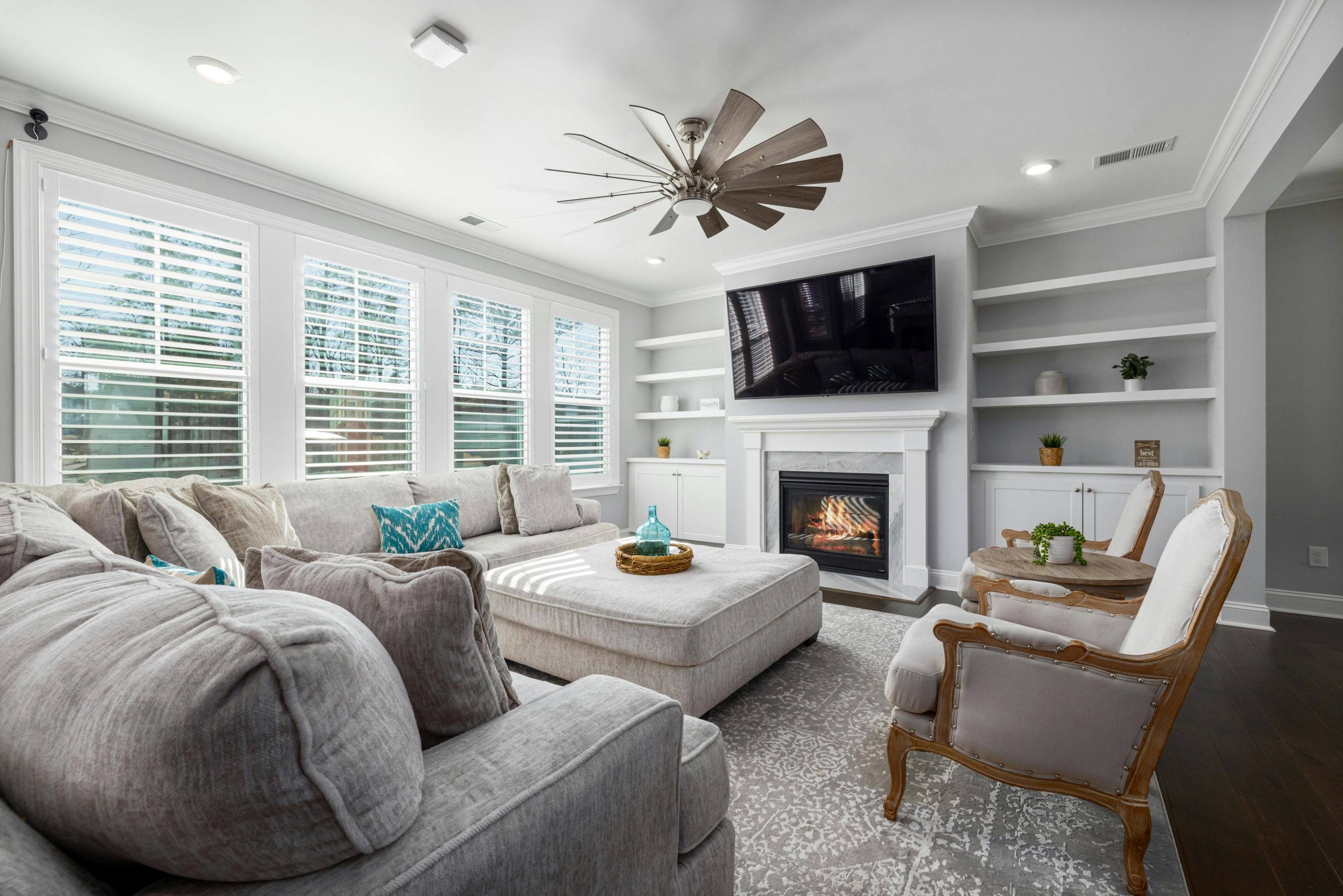 Bright and elegant living room featuring a fireplace and comfortable seating.