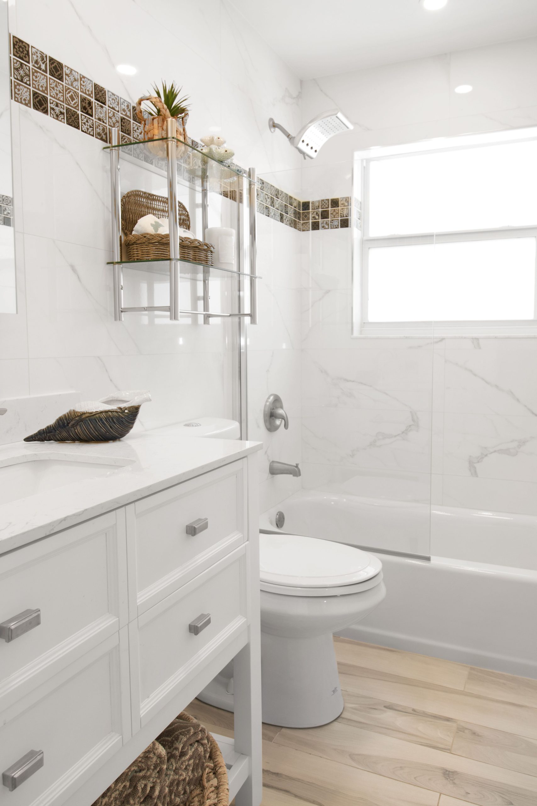 Bright and modern bathroom interior showcasing minimalist design, white tiles, and natural light.