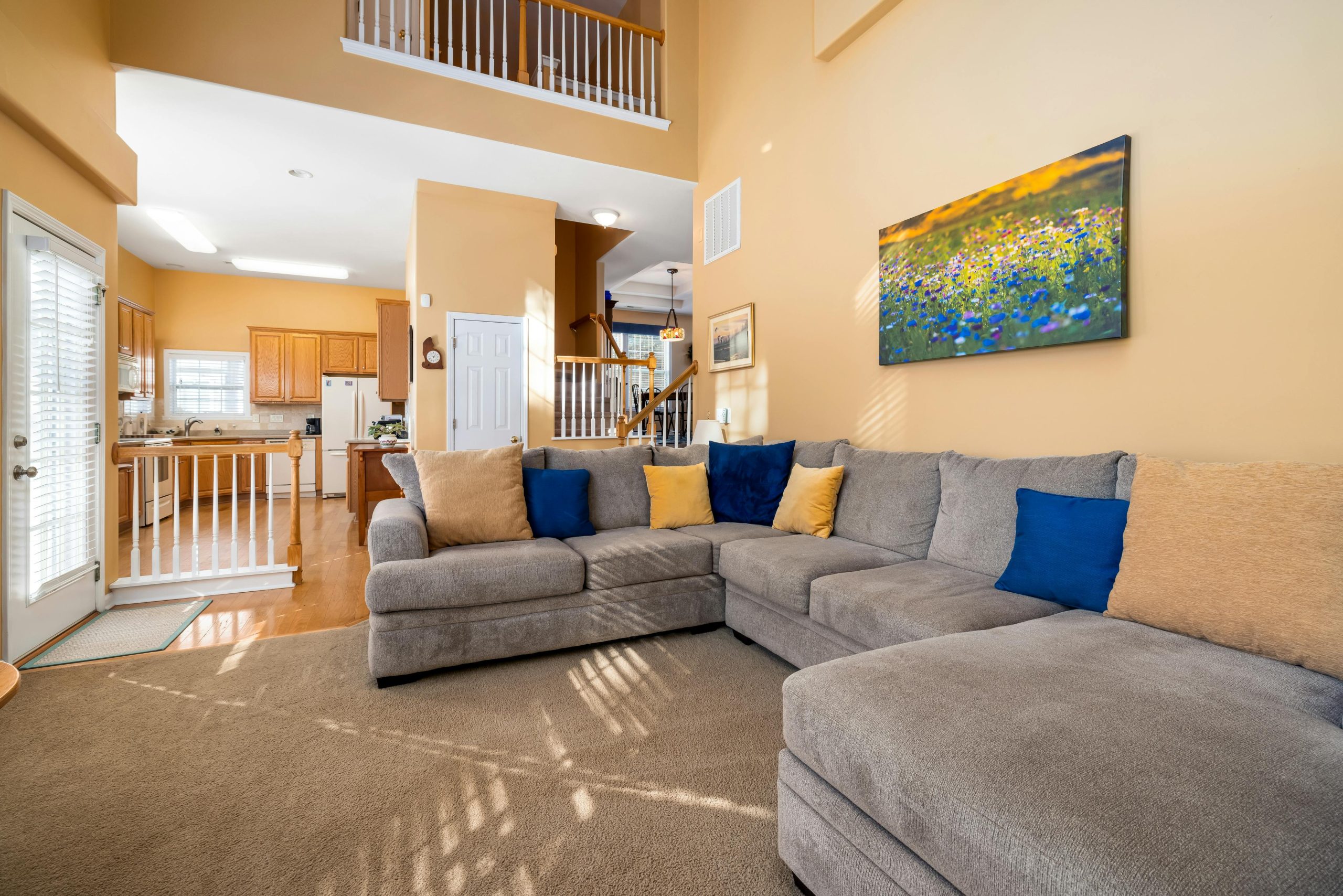 Bright and spacious living room showcasing a cozy grey sofa and modern interior design.