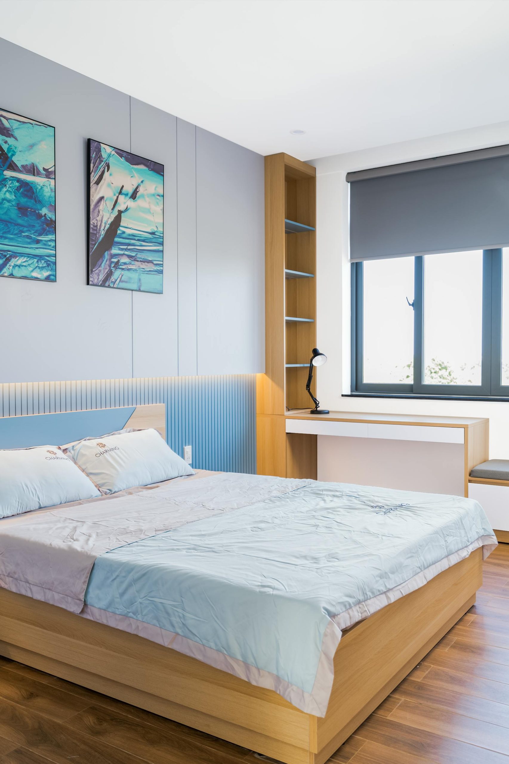 Bright, contemporary bedroom interior with wooden accents and urban view.