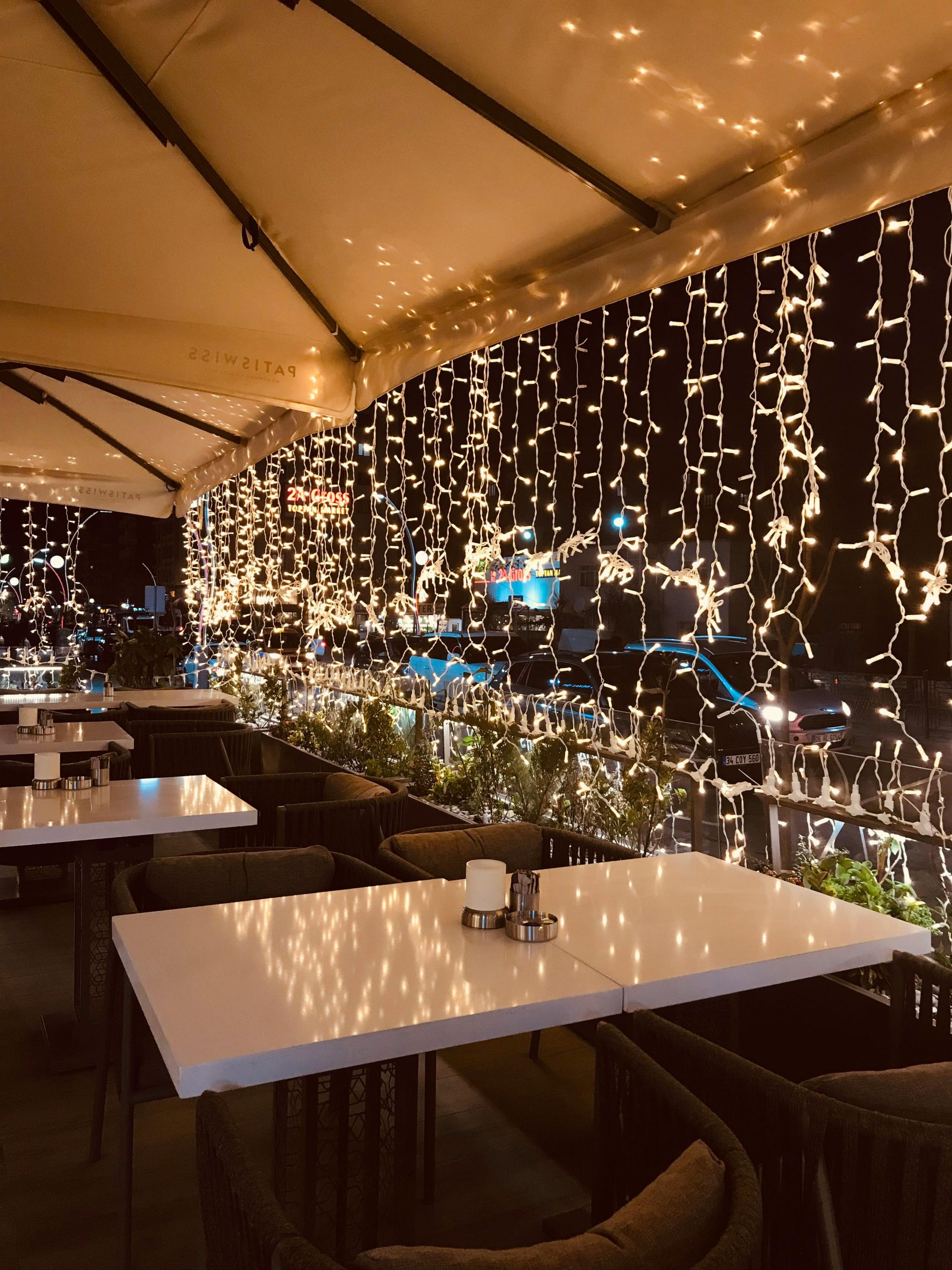 Charming illuminated outdoor restaurant with decorative lights in Ankara, Turkey at night.