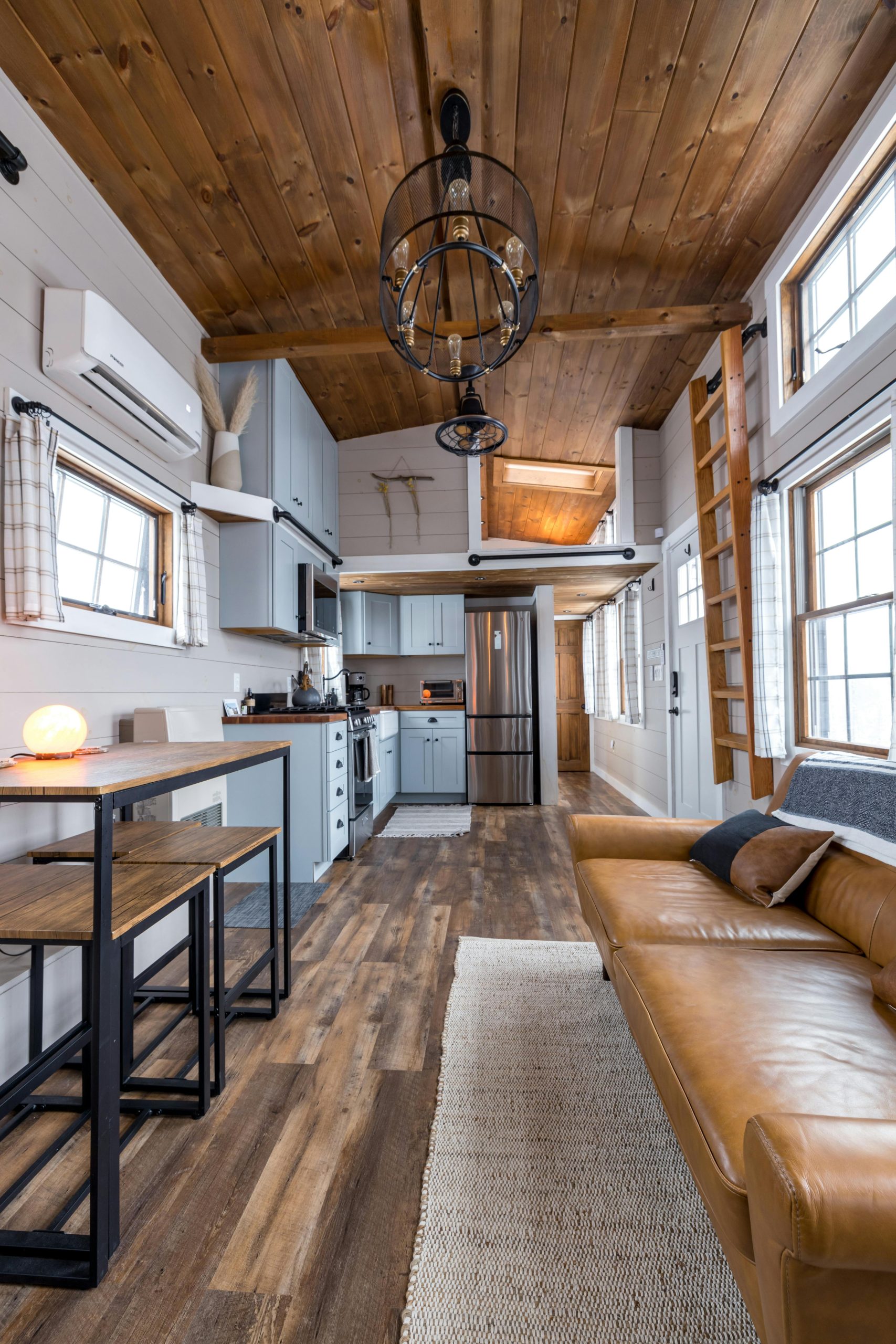 Cozy and contemporary tiny house interior featuring minimalist design and wooden accents.