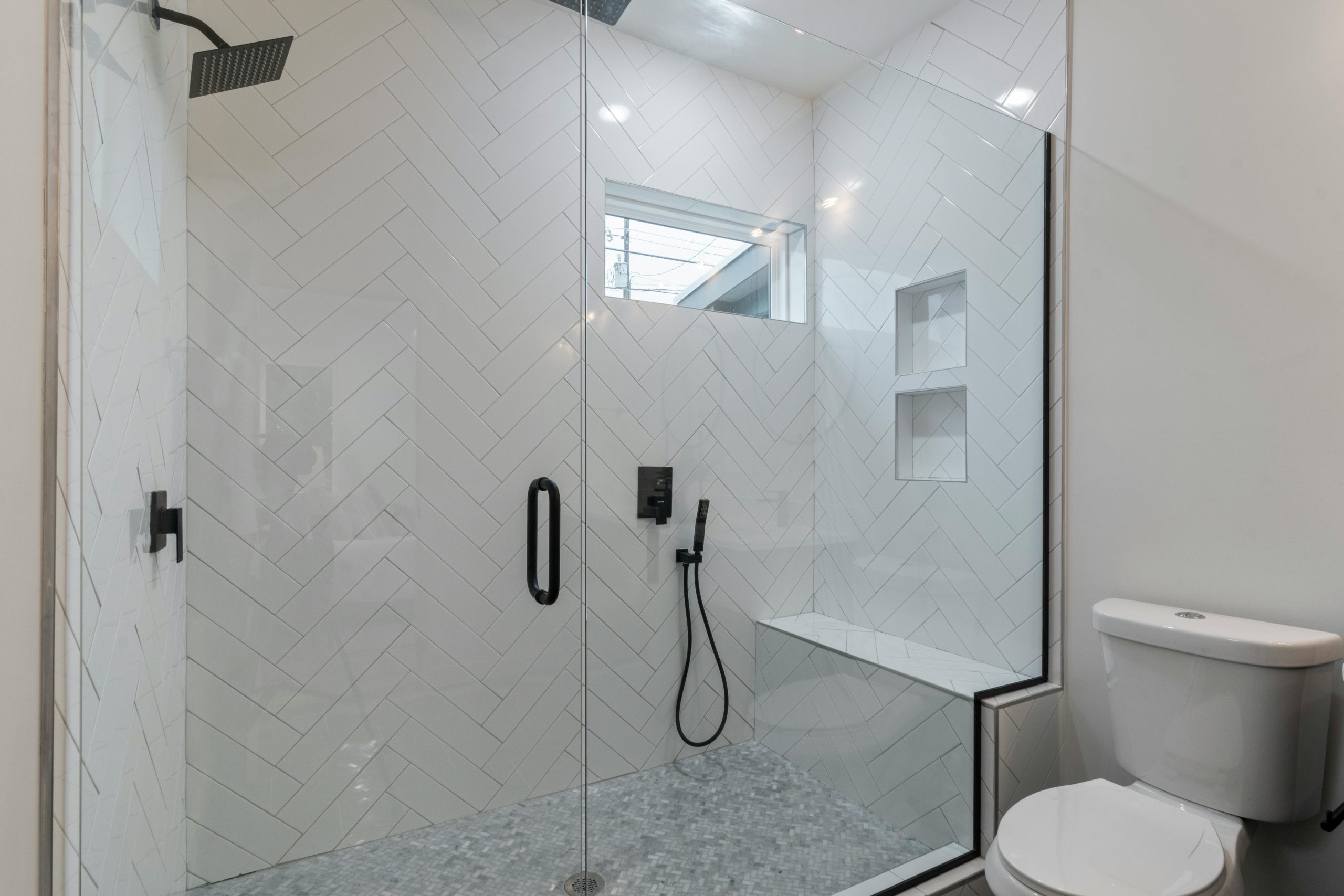 Elegant bathroom featuring a sleek walk-in shower and contemporary design.
