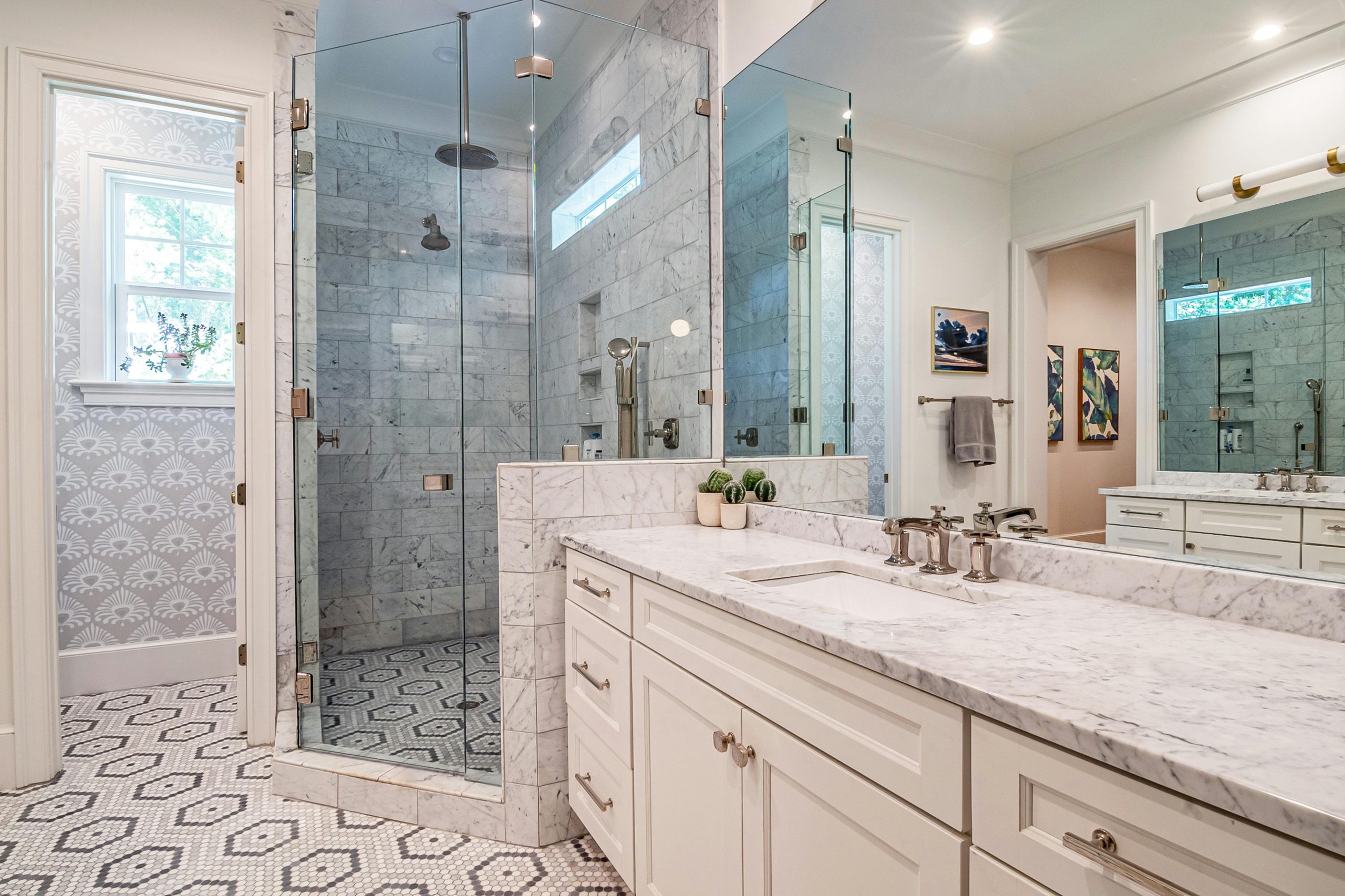 Elegant bathroom with marble countertops, glass shower, and stylish Mediterranean decor.
