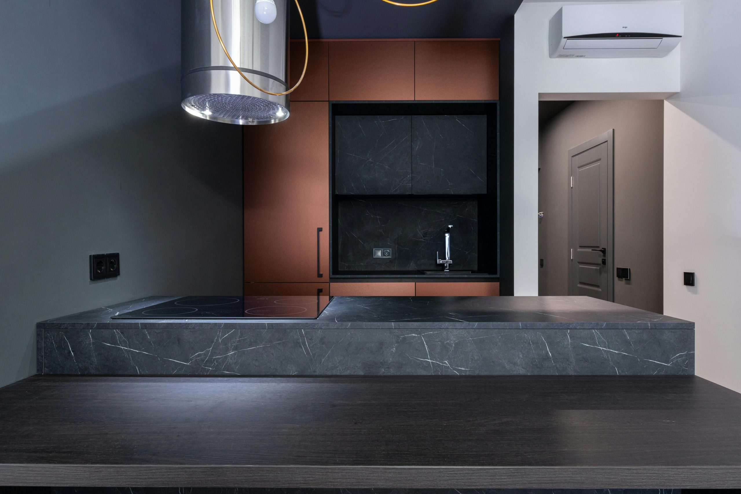 Explore a modern kitchen with sleek marble countertops, stylish cabinetry, and a minimalist aesthetic.