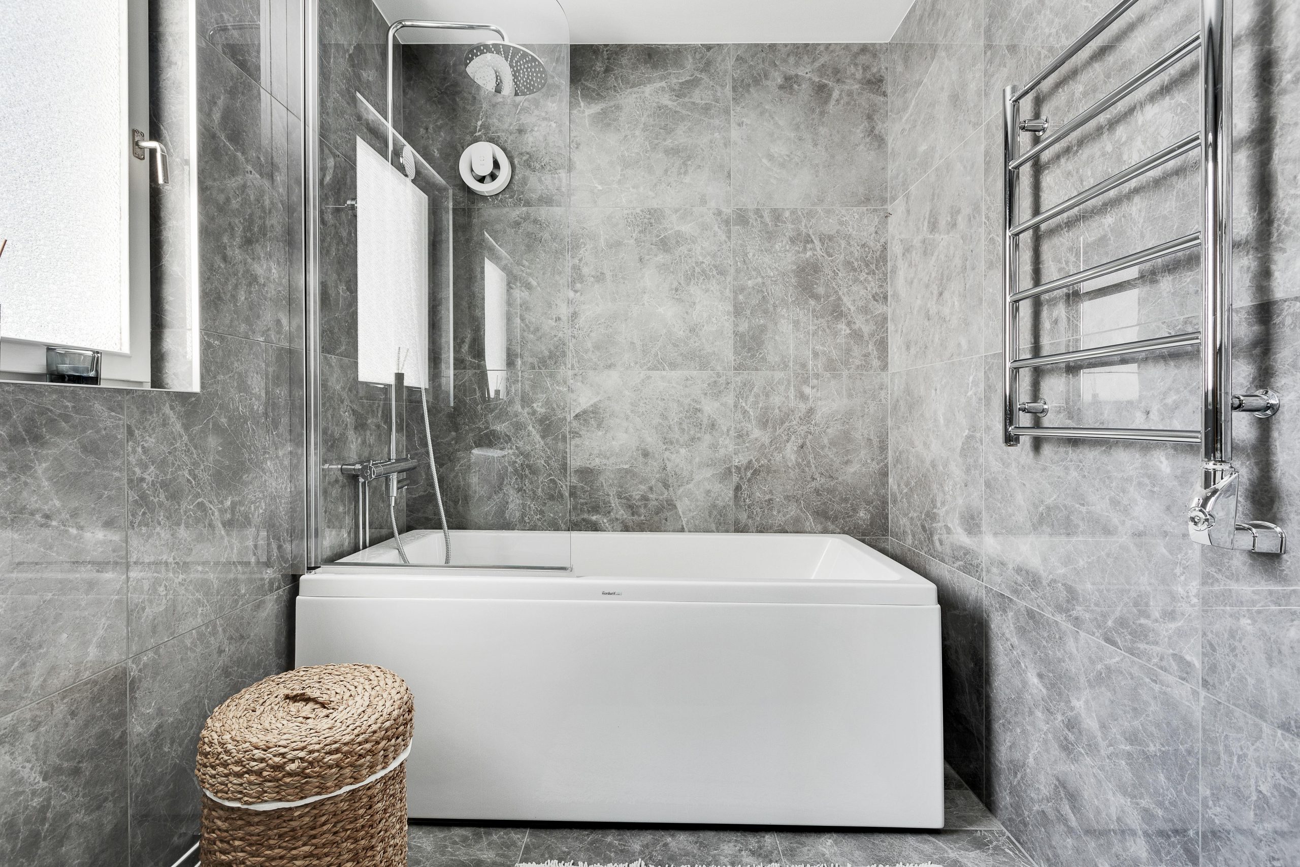 Explore a sleek and contemporary gray marble bathroom with elegant fixtures and abundant natural light.