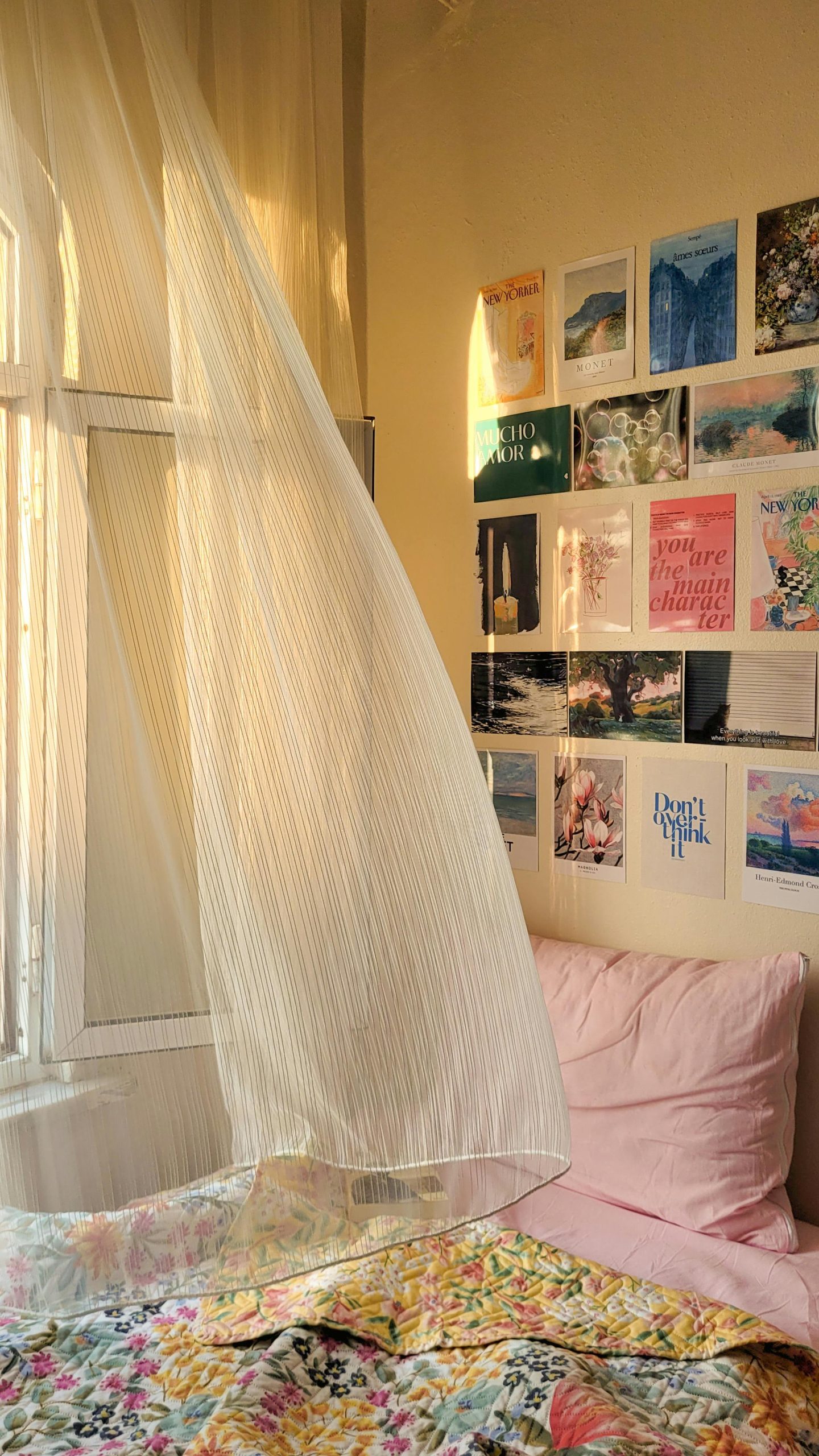 Inviting bedroom interior with sunlight streaming through sheer curtains onto a bed and artistic wall decor.
