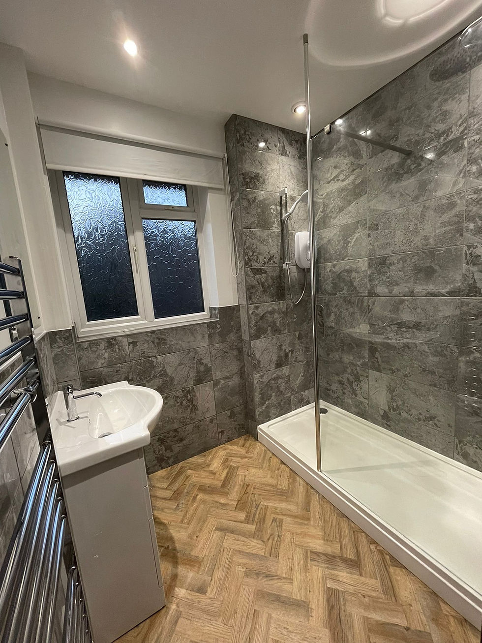 Modern Grey stone tiled bathroom with walk in shower