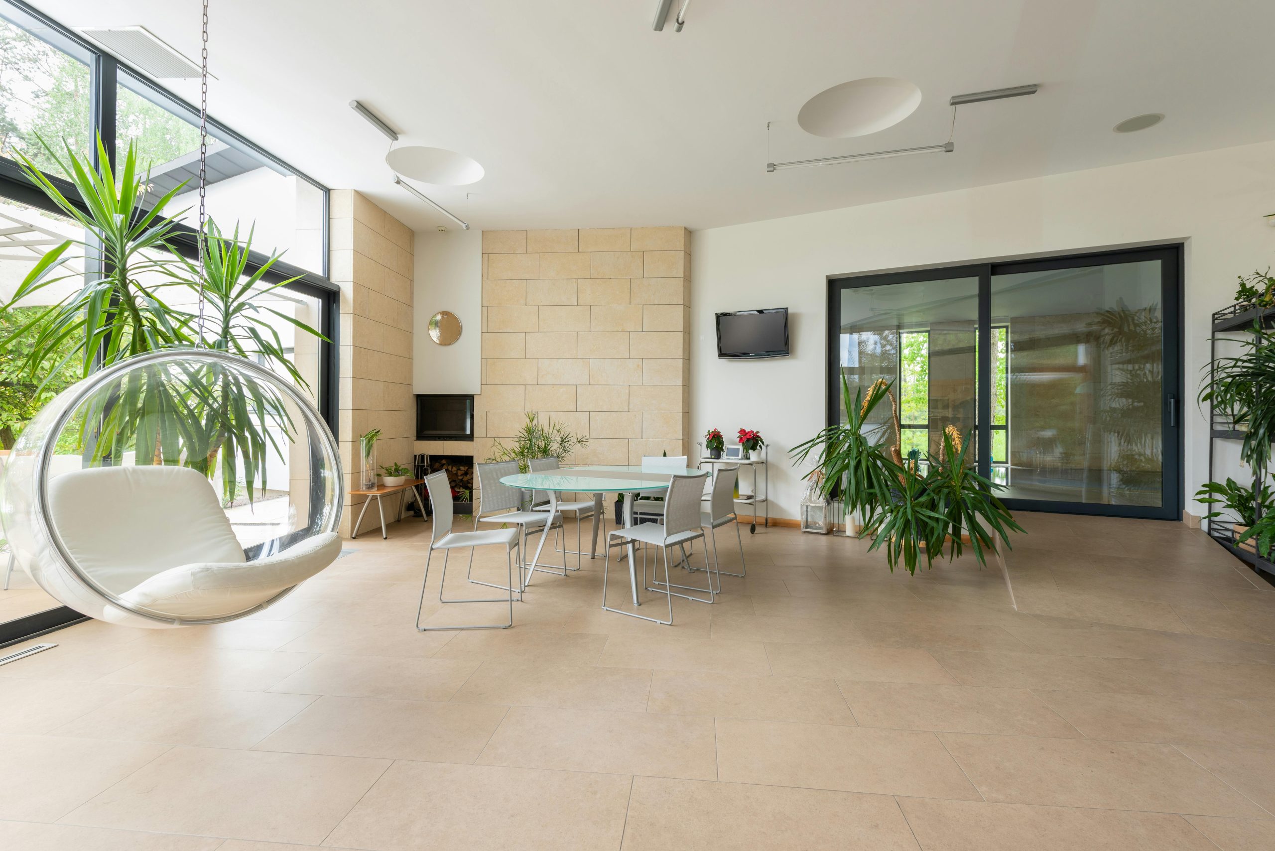 Modern large apartment with contemporary interior and table with chairs in bright daylight