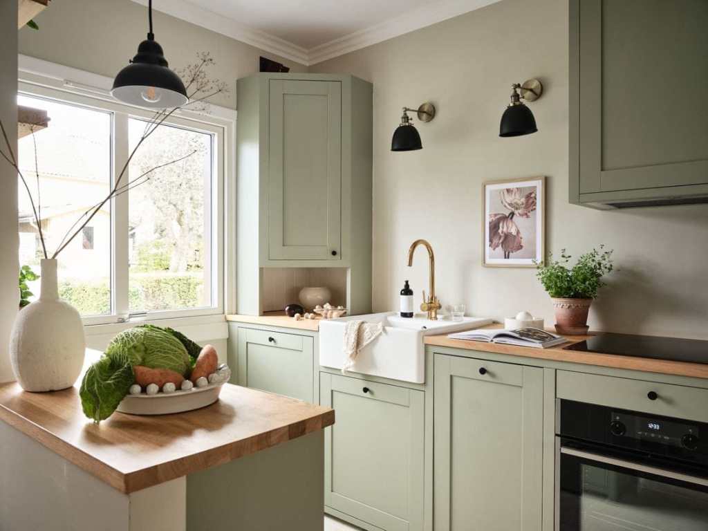 Sage green kitchen cabinets in a green color palette apartment - COCO LAPINE DESIGNCOCO LAPINE DESIGN