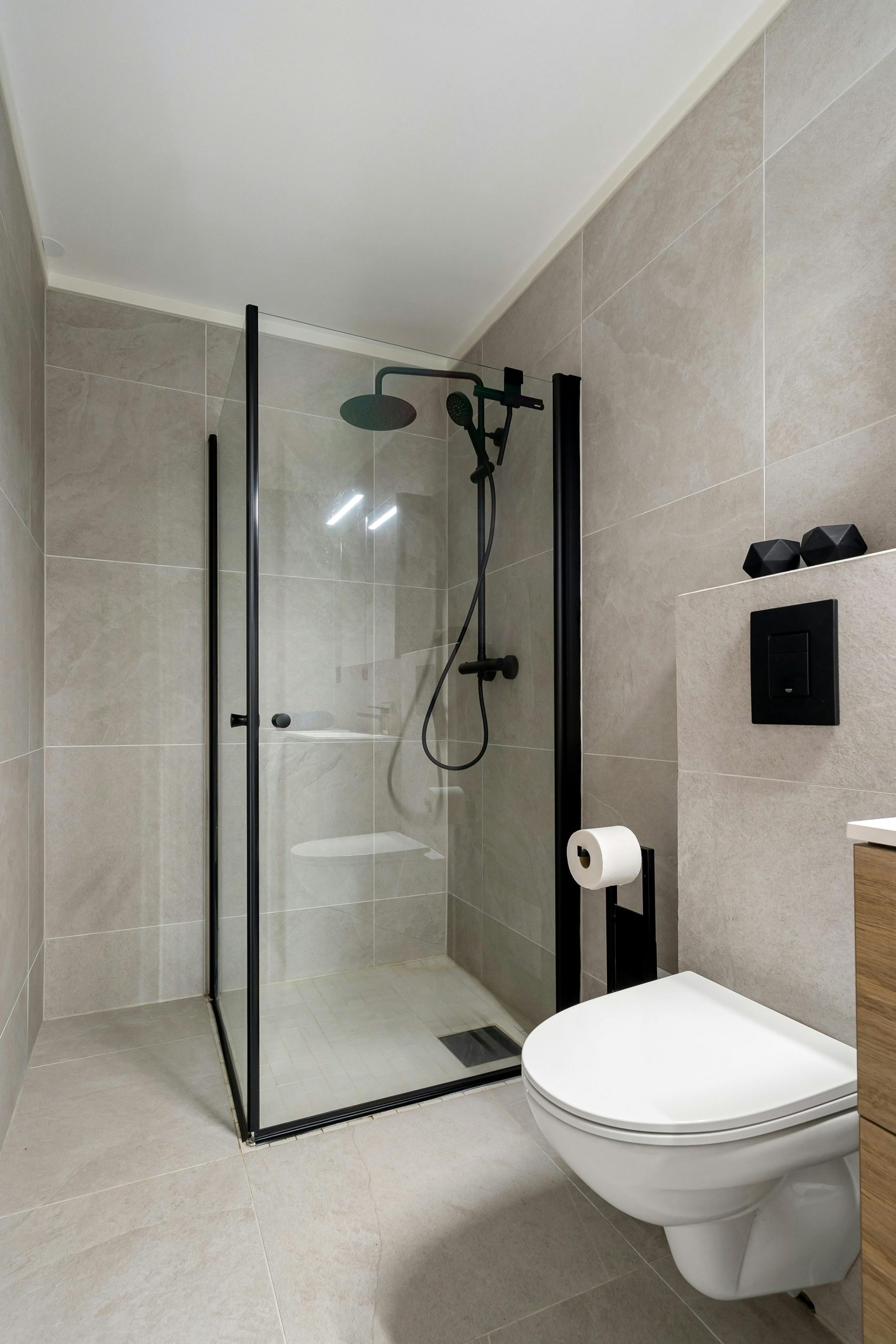 Sleek modern bathroom featuring a frameless glass shower and minimalist design.