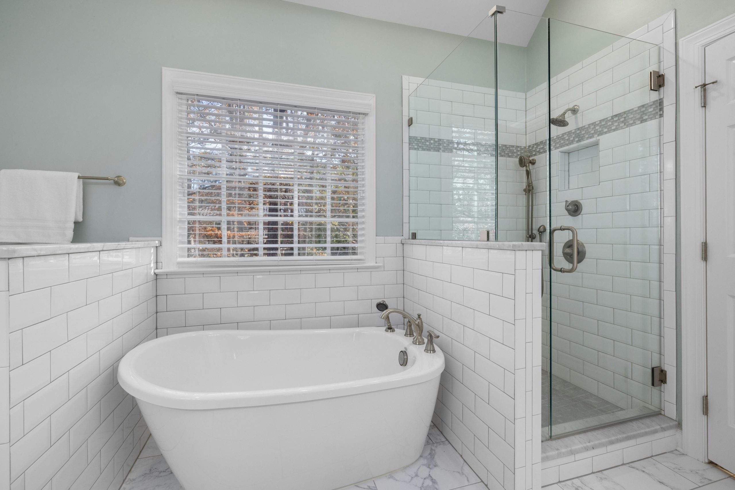Sleek modern bathroom featuring a freestanding tub and glass shower enclosure. Ideal for home interiors.