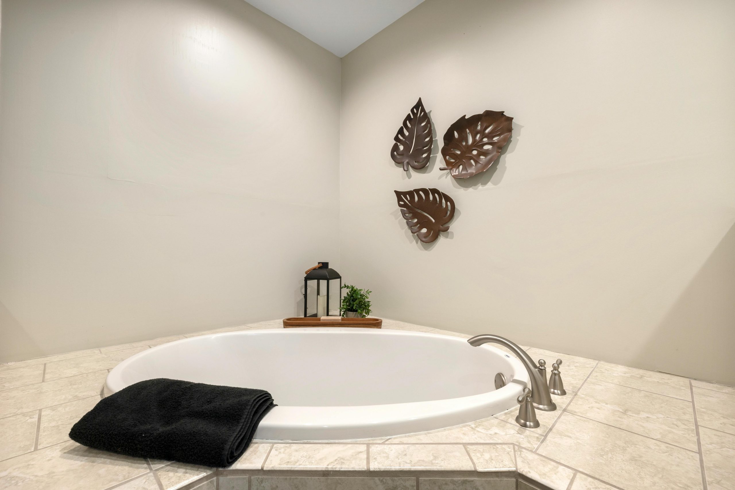 Spacious bathroom featuring a luxury bathtub, elegant decor, and soothing ambiance for ultimate relaxation.
