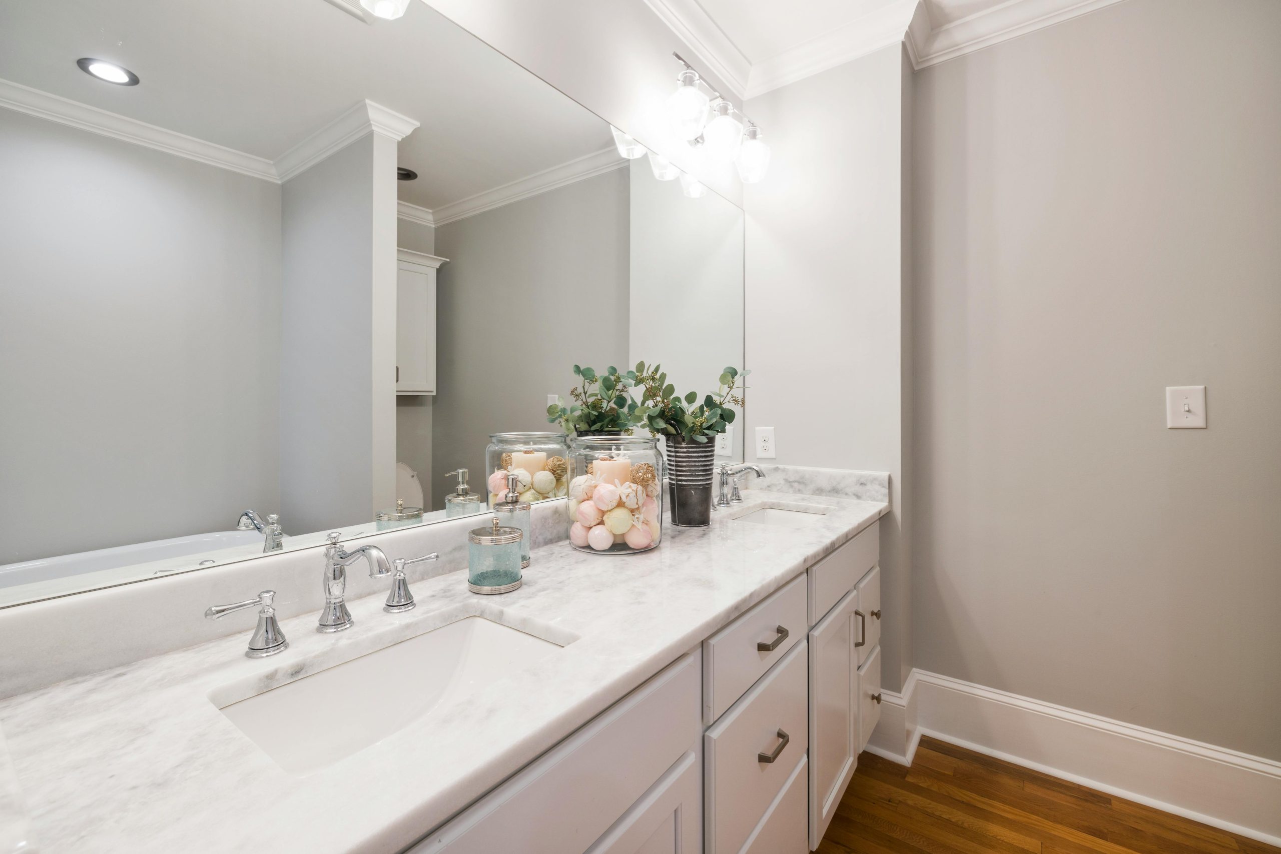 Spacious bathroom featuring a stylish marble countertop and elegant modern accessories.