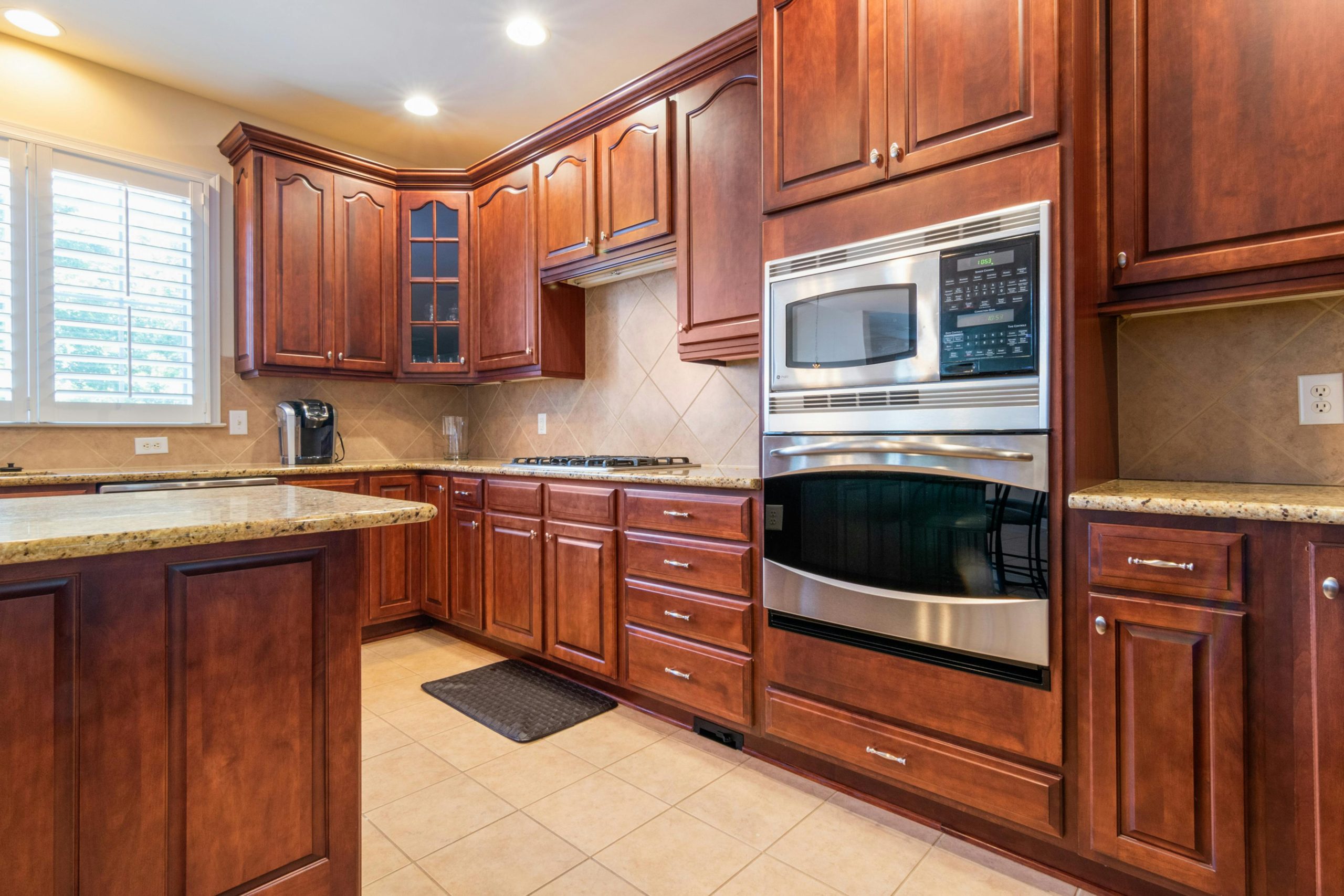 Spacious kitchen with wooden cabinetry and built-in appliances. Elegant and functional interior design.
