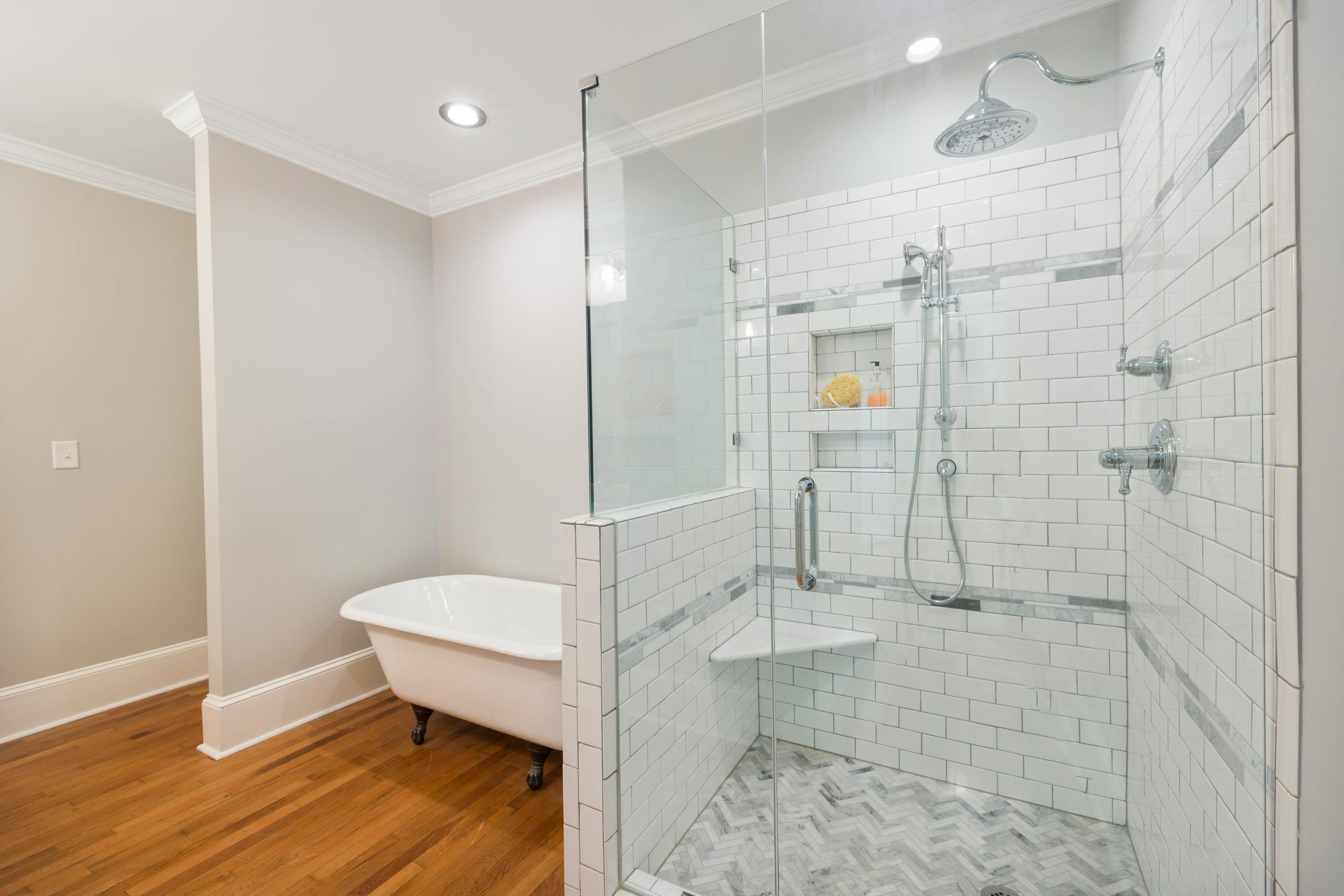 Spacious modern bathroom featuring a glass door shower and freestanding bathtub.