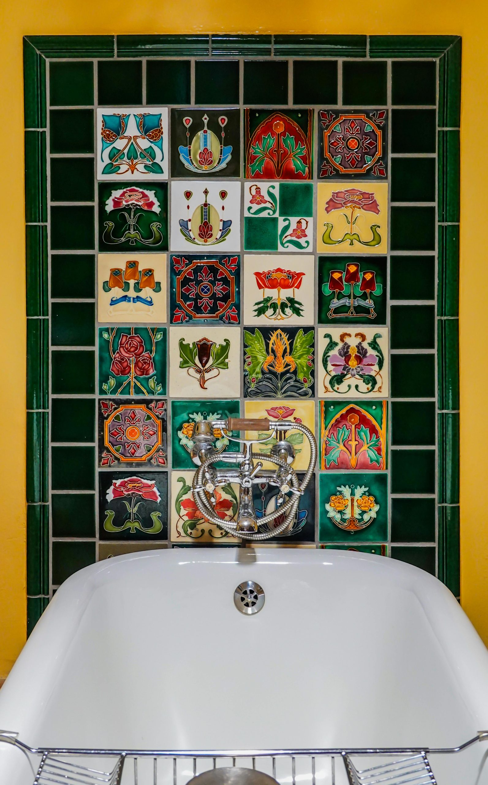 Vibrant art deco bathroom featuring vintage, decorative tiles on wall.