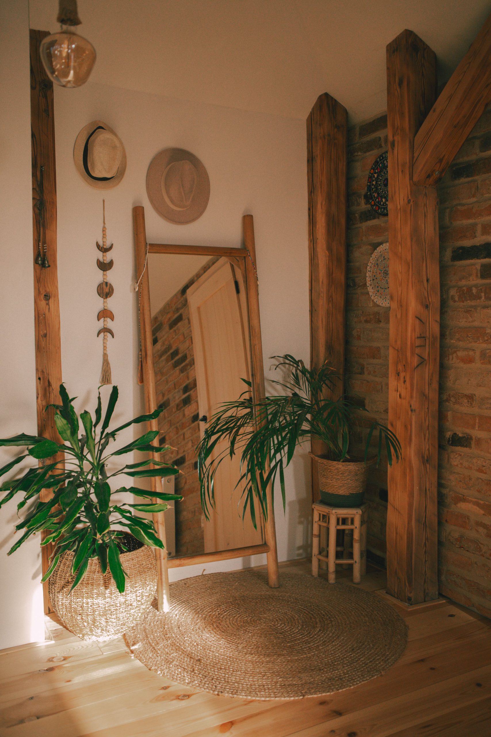 Warm, inviting interior space featuring rustic wood, lush greenery, and natural decorations.