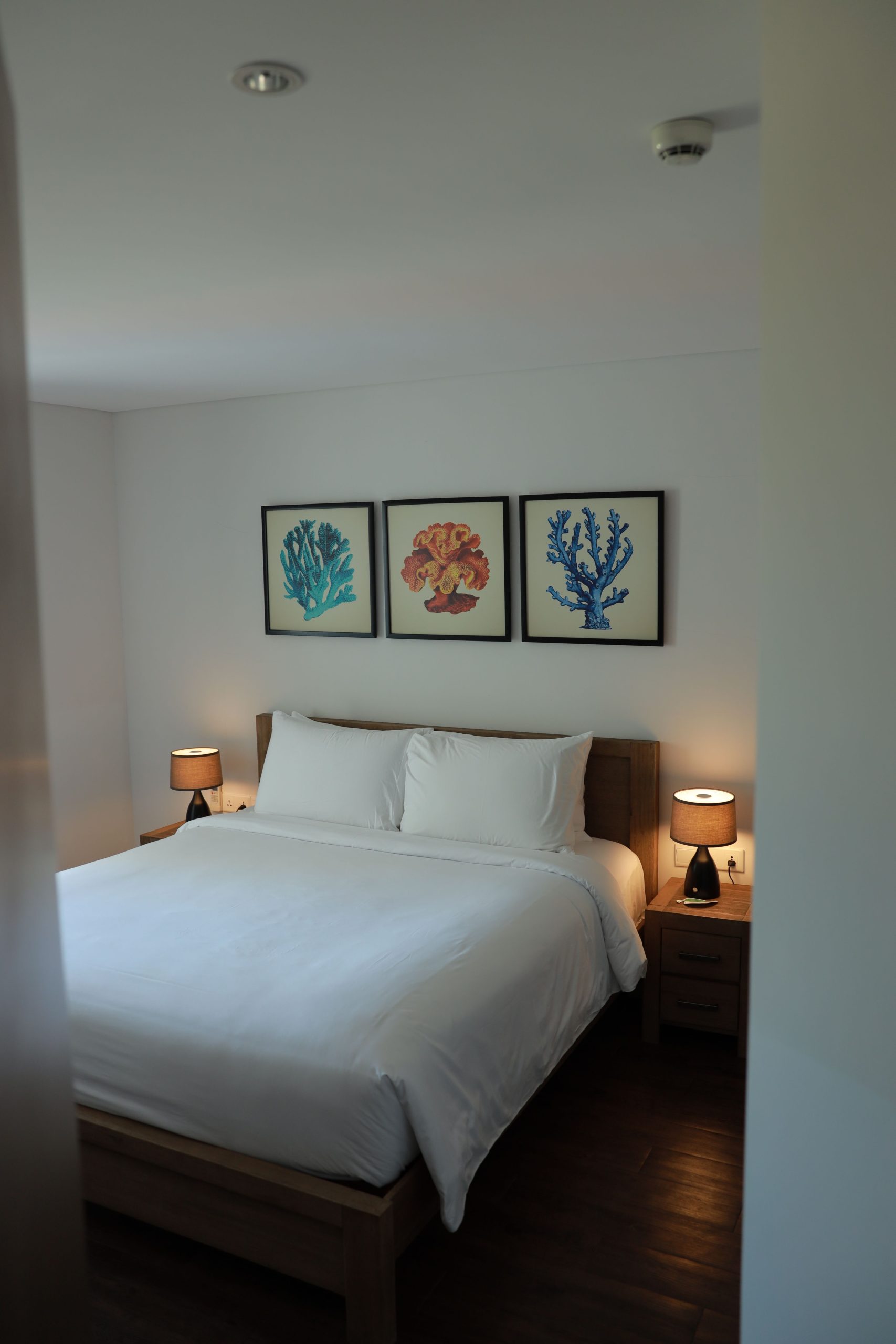 A bright and cozy bedroom interior featuring modern artwork and minimalistic design for comfort and style.
