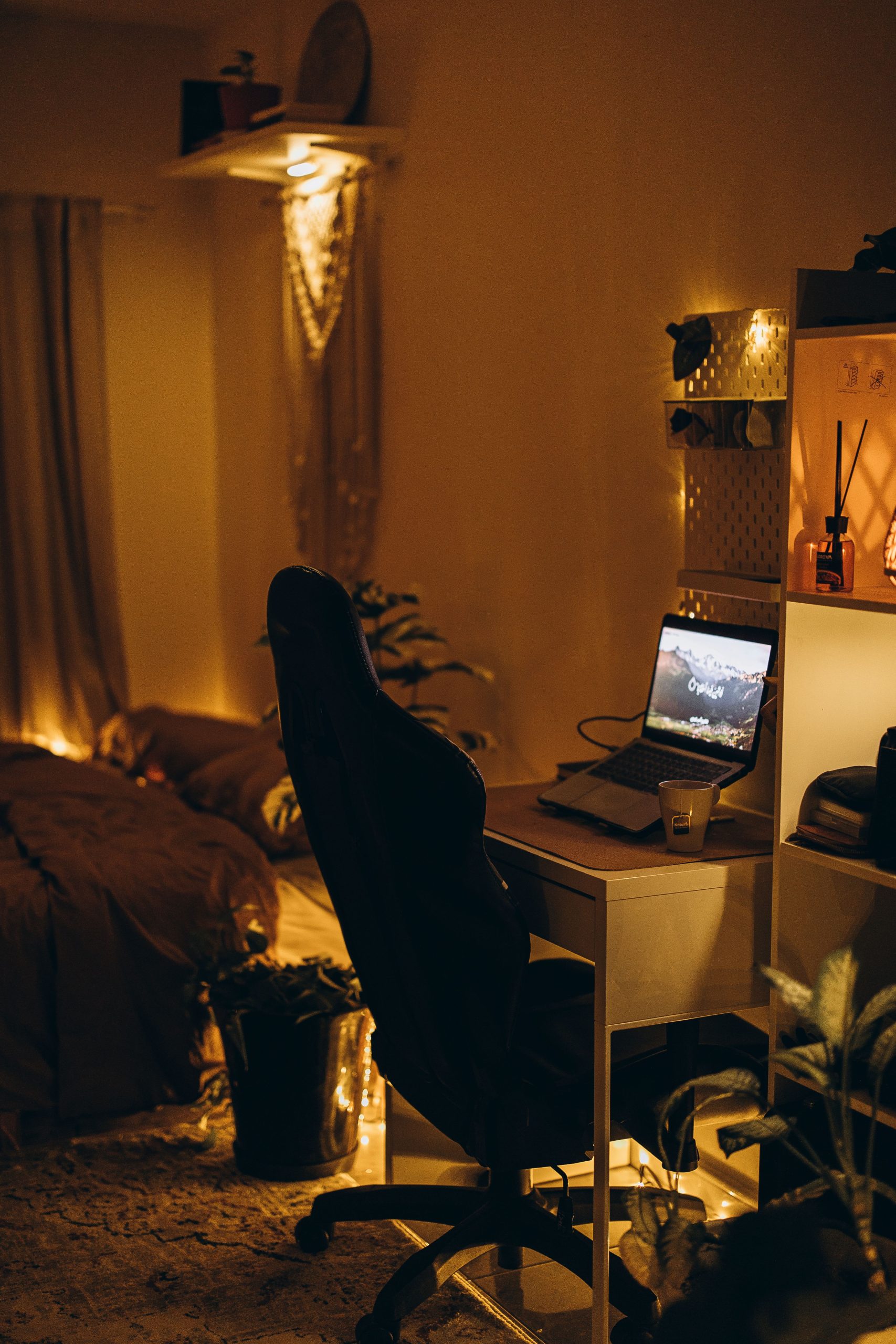 A cozy bedroom with a warm ambiance and workspace setup ideal for relaxation and productivity.
