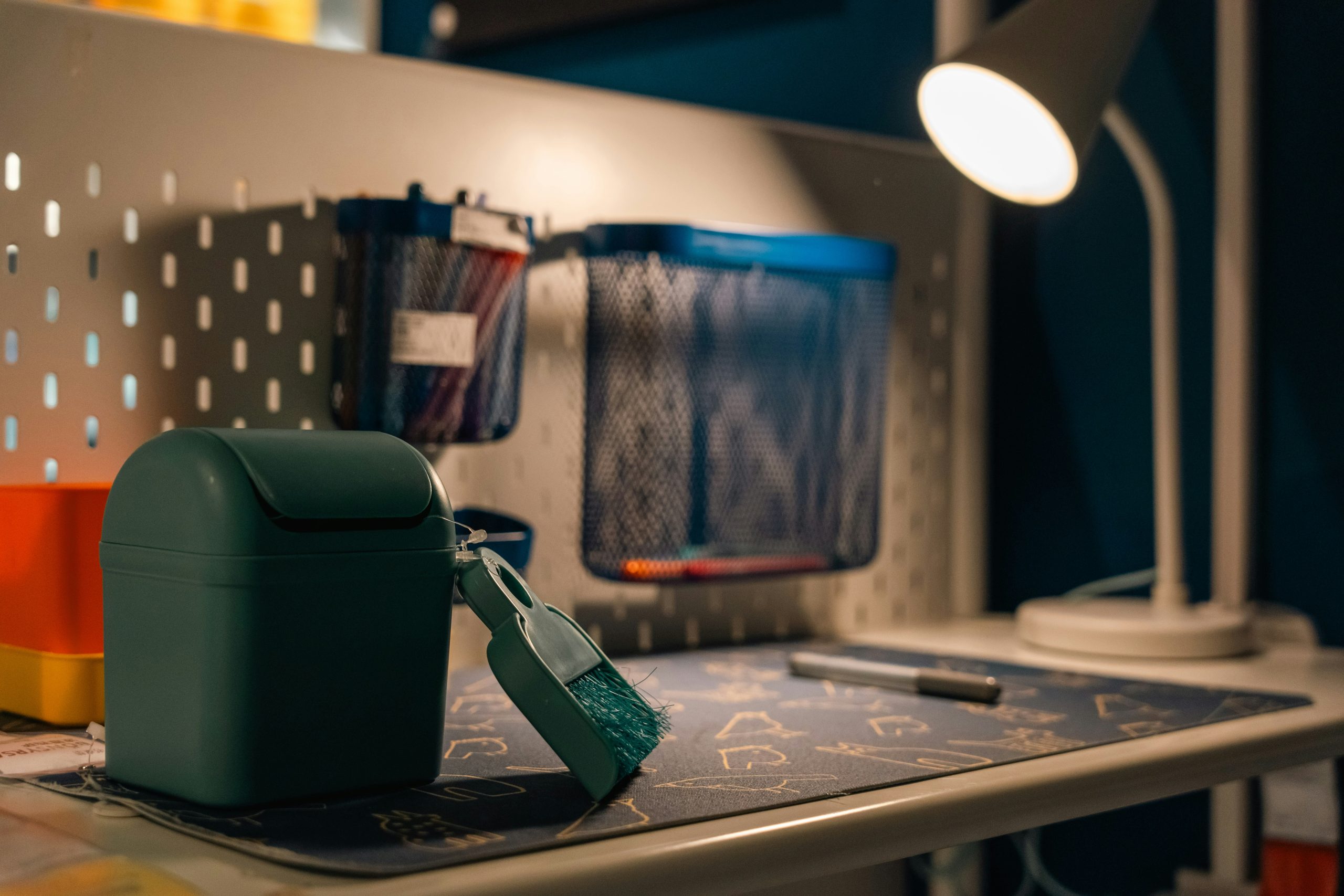 a green lunch box sitting on top of a desk