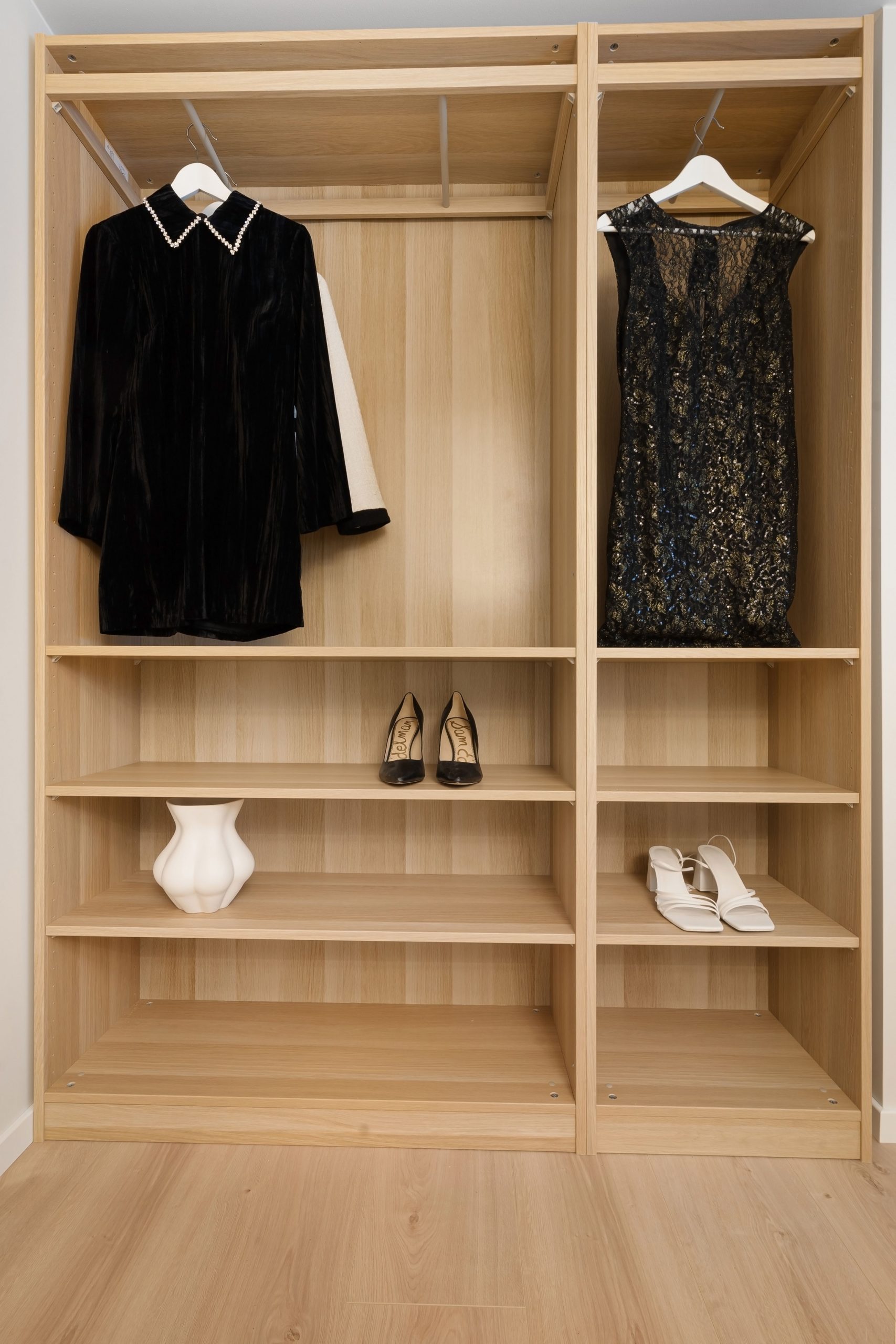 A minimalist wardrobe showcasing elegant dresses and stylish heels, emphasizing simplicity and elegance.