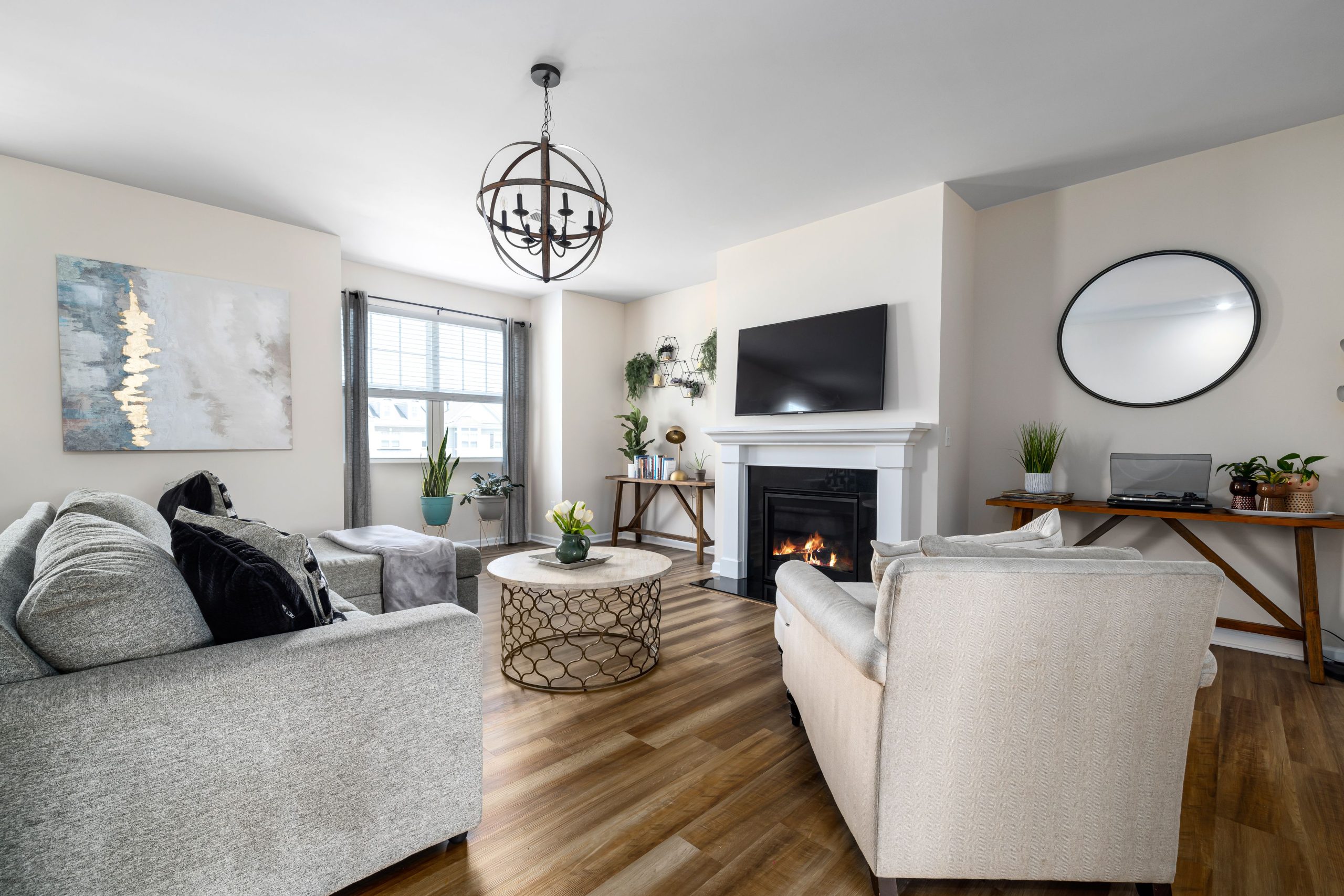A stylish and cozy living room featuring a fireplace, modern furniture, and elegant decor.